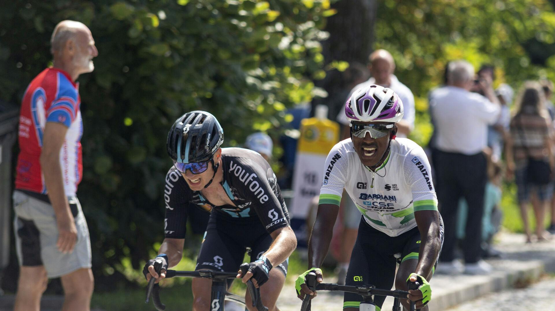 L-R Tobias Lund Andersen (Denmark) and Henok Mulubrhan (Eritrea) compete in the Sazka Tour cycling race, final 4th stage, on August 7, 2022, in Sternberk, Czech Republic. Photo/Stanislav Helona (CTK via AP Images)