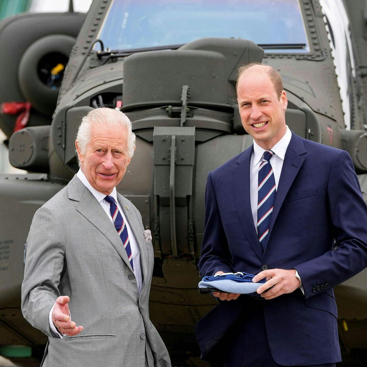 Britain's King Charles III officially hands over the role of Colonel-in-Chief of the Army Air Corps to Britain's Prince William, Prince of Wales in front of an Apache helicopter at the Army Aviation Centre in Middle Wallop, England, on May 13, 2024. (Photo by Kin Cheung / POOL / AFP)