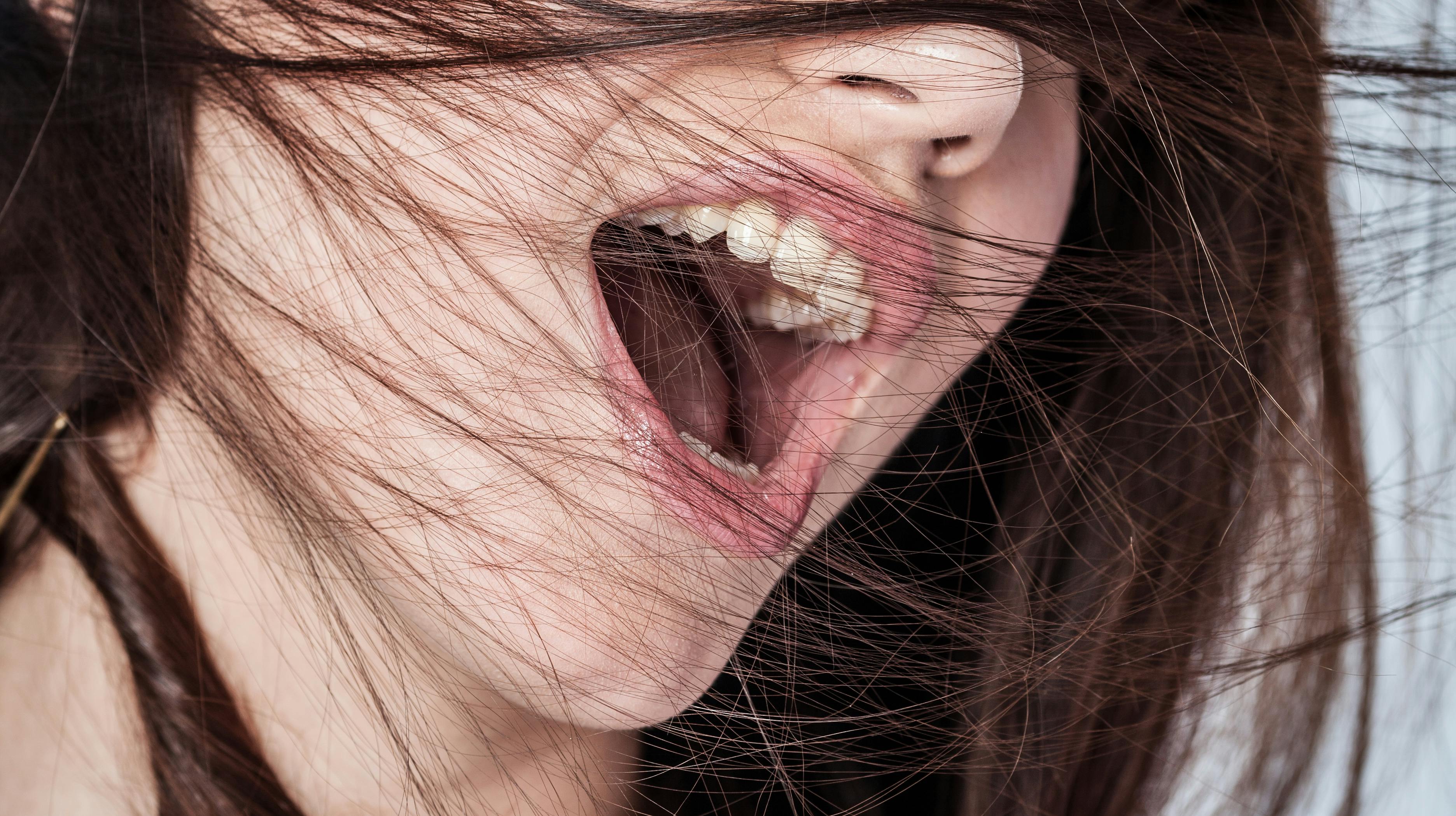 Portrait of a young woman shouting in ecstasy