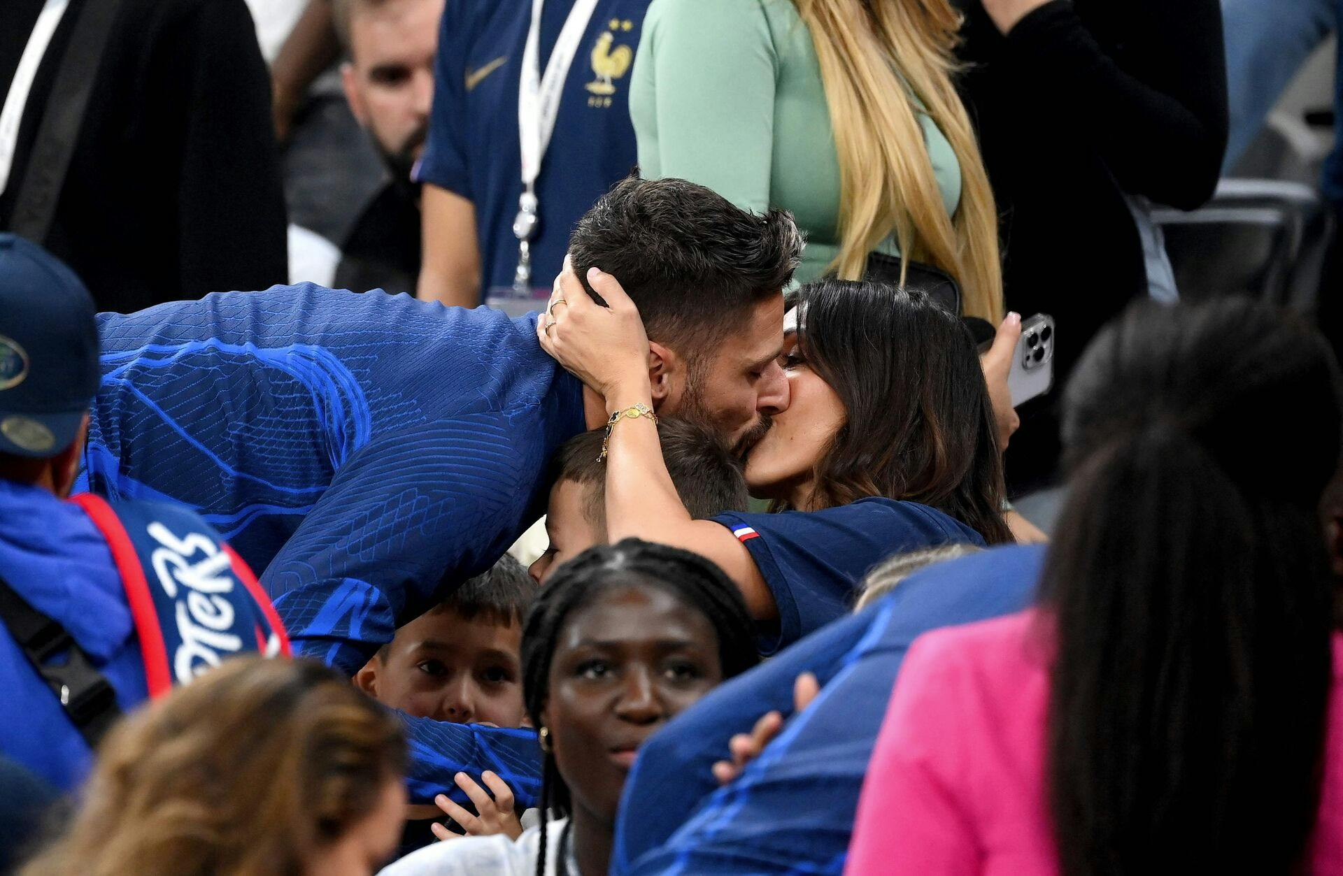 France's forward Olivier Giroud kisses his wife Jennifer after the Qatar 2022 World Cup football semi-final match between France and Morocco at the Al-Bayt Stadium in Al Khor, north of Doha on December 14, 2022. (Photo by FRANCK FIFE / AFP)