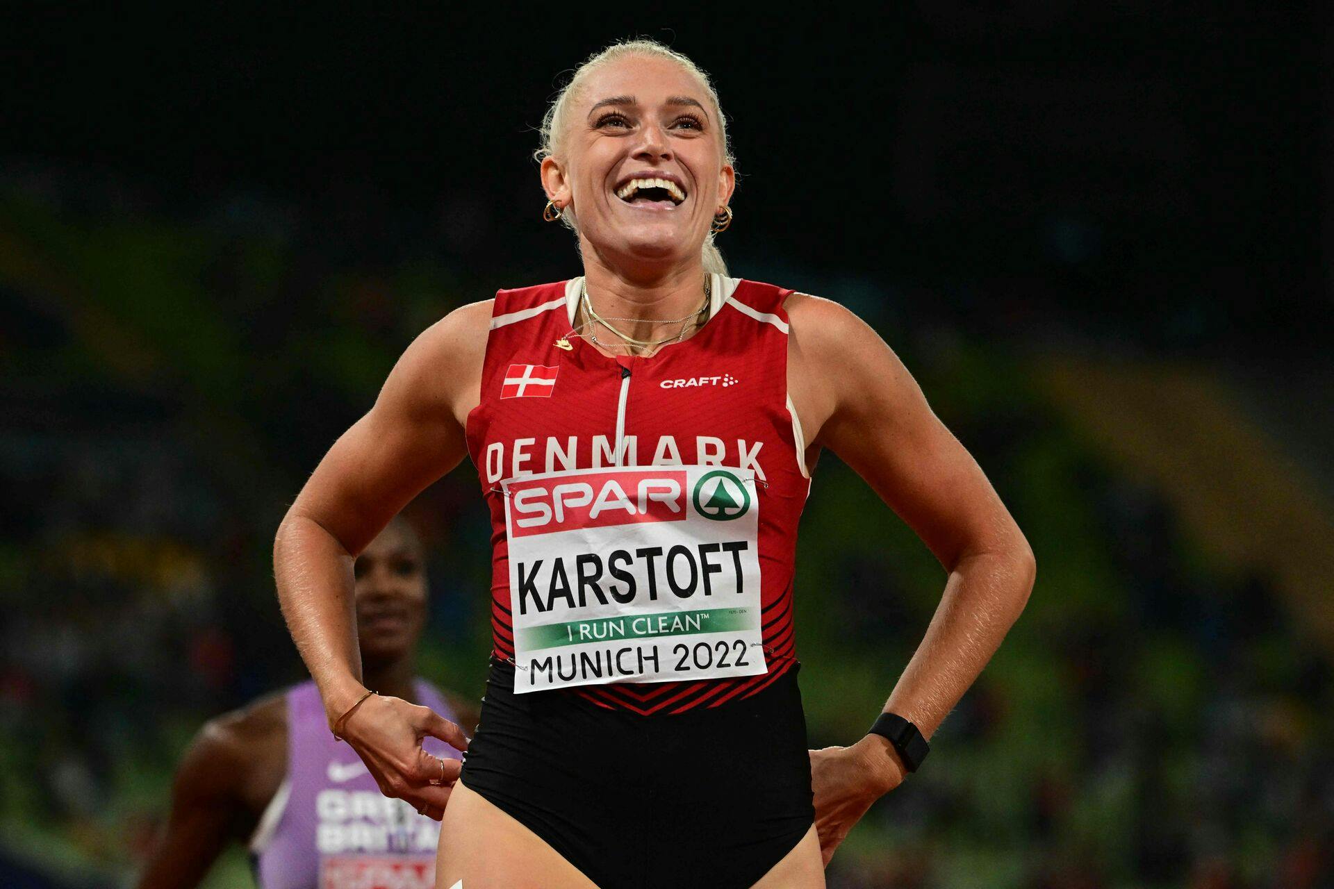 Denmark's Ida Karstoft celebrates winning the bronze medal in the women's 200m final during the European Athletics Championships at the Olympic Stadium in Munich, southern Germany on August 19, 2022. (Photo by INA FASSBENDER / AFP)