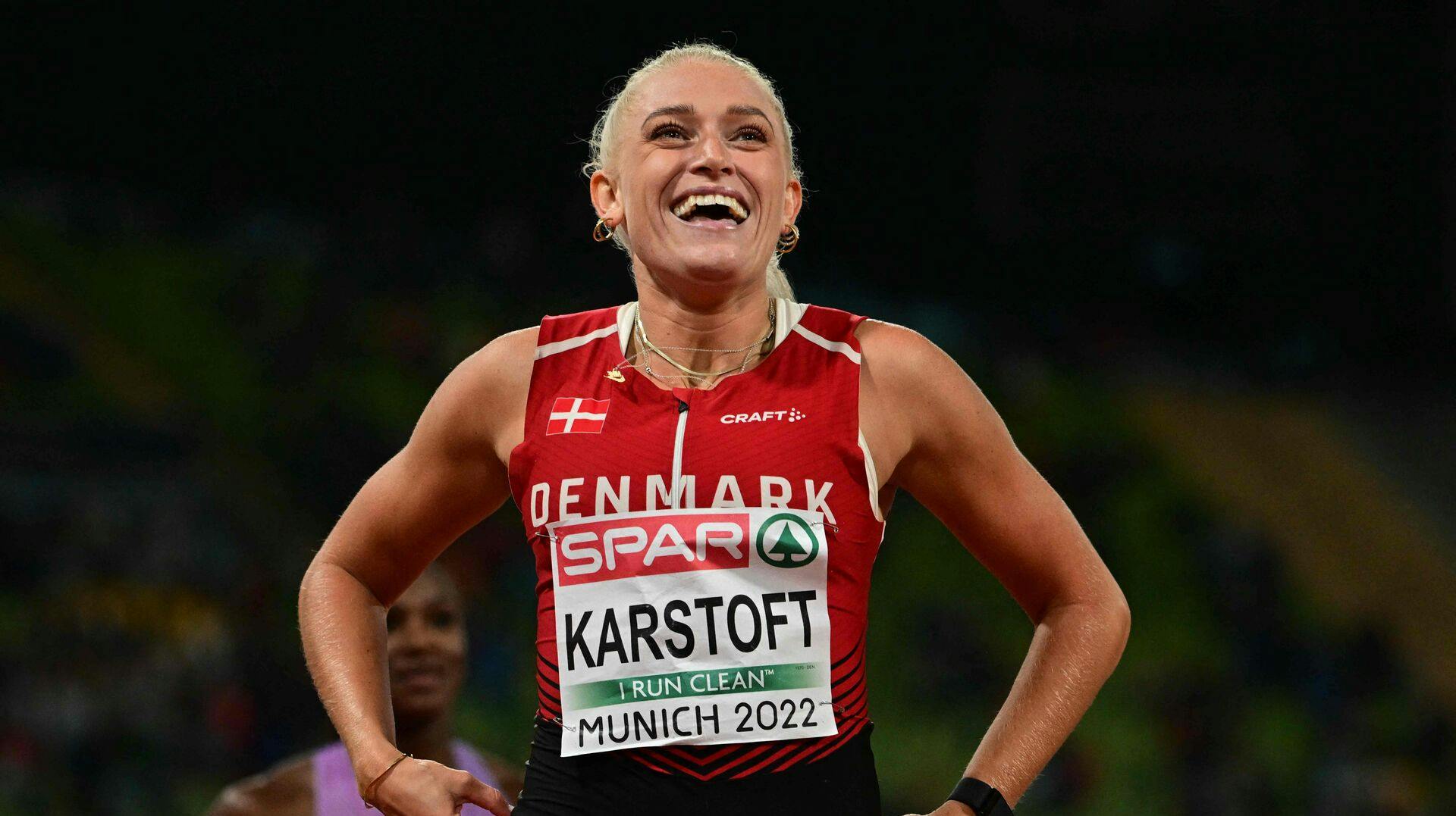 Denmark's Ida Karstoft celebrates winning the bronze medal in the women's 200m final during the European Athletics Championships at the Olympic Stadium in Munich, southern Germany on August 19, 2022. (Photo by INA FASSBENDER / AFP)
