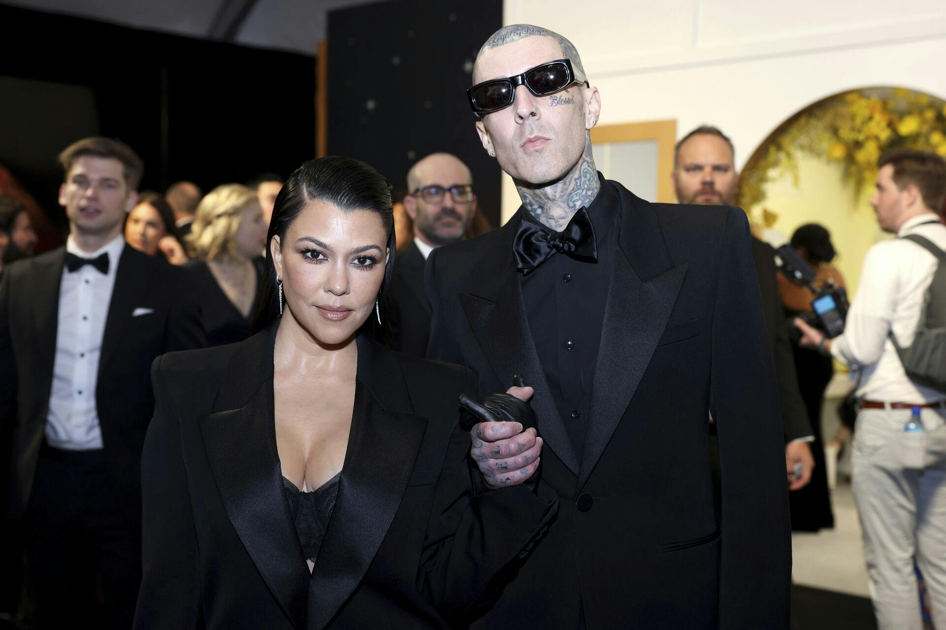 Kourtney Kardashian, left, and Travis Barker enhance their look and style at the 75th Emmy Awards on Monday, Jan. 15, 2024 at the Peacock Theater at L.A. Live in Los Angeles. (Photo by Colin Young-Wolff/Invision for the Television Academy/AP Images)