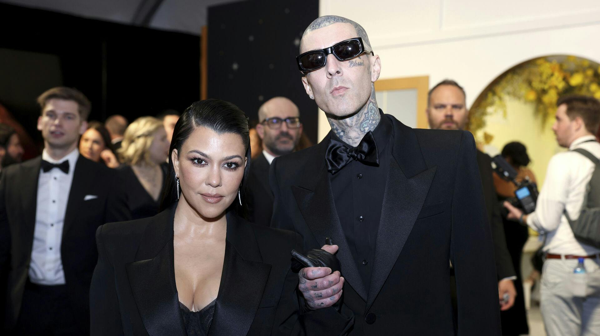Kourtney Kardashian, left, and Travis Barker enhance their look and style at the 75th Emmy Awards on Monday, Jan. 15, 2024 at the Peacock Theater at L.A. Live in Los Angeles. (Photo by Colin Young-Wolff/Invision for the Television Academy/AP Images)