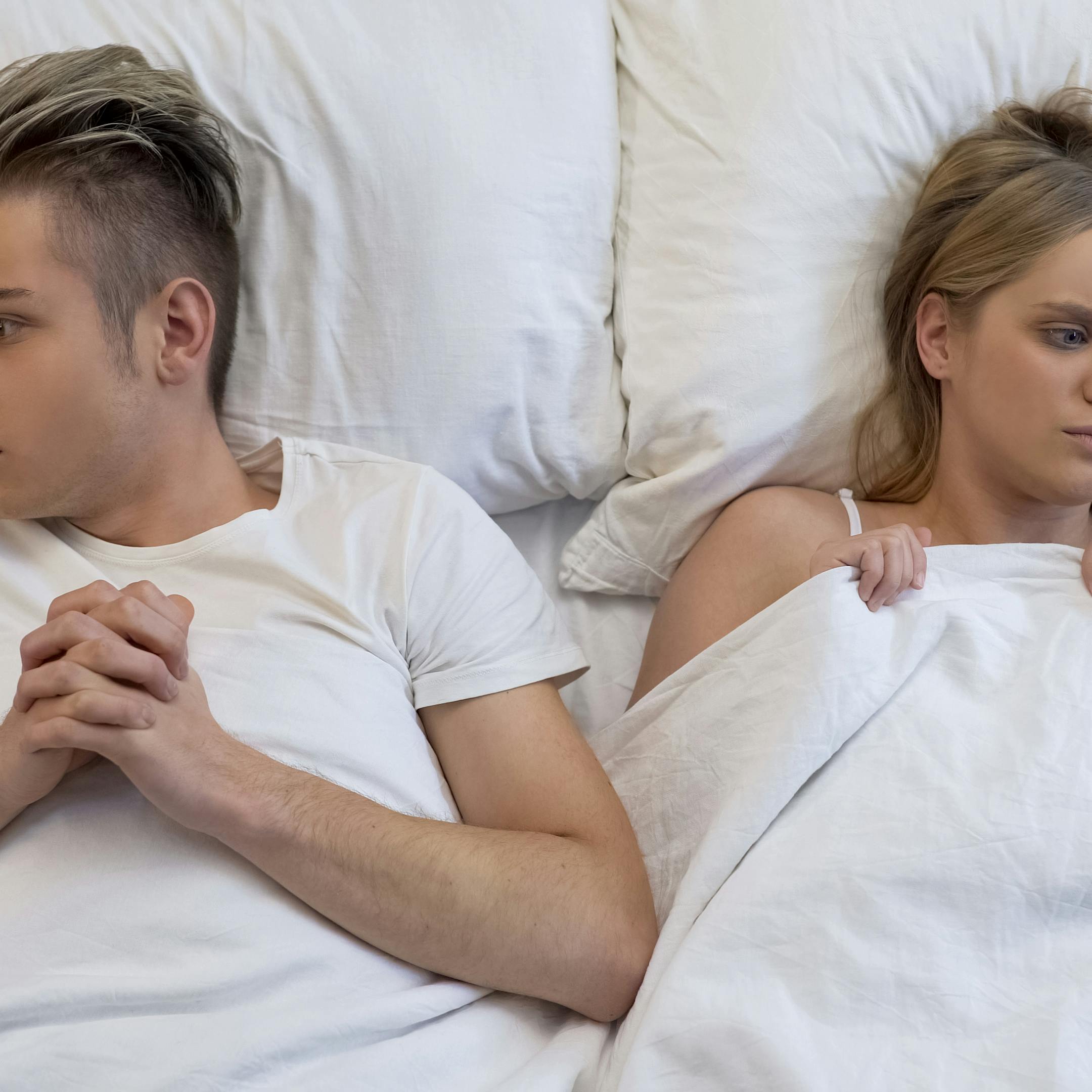 Shocked couple thinking over first intimate experience, lack of sex education