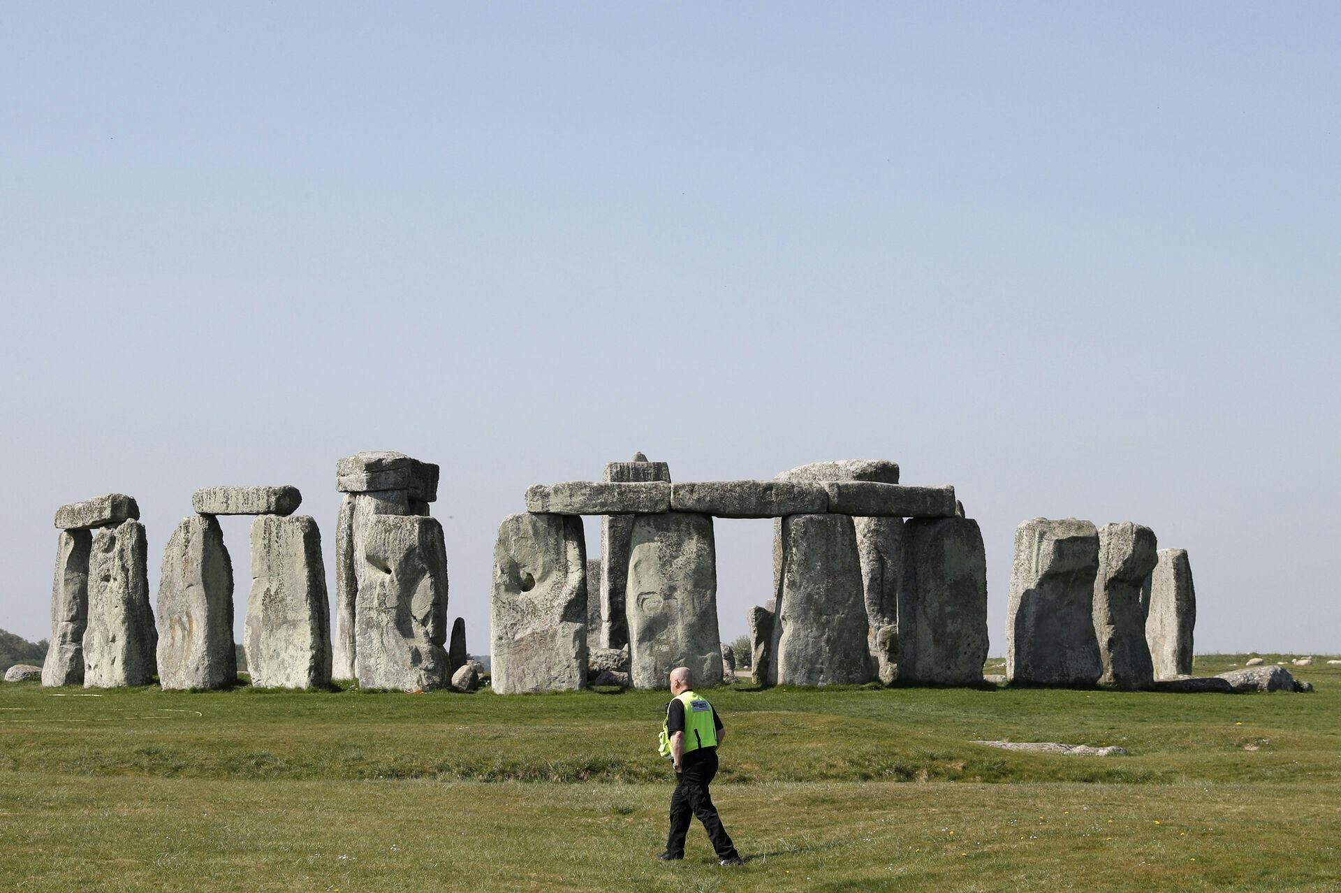 Security guards patrol the prehistoric monument at Stonehenge in southern England, on April 26, 2020, closed during the national lockdown due to the novel coronavirus COVID-19 pandemic. Britain's health ministry on Saturday said 813 more people had died after testing positive for COVID-19 in hospital, taking the death toll to 20, 319. Adrian DENNIS / AFP