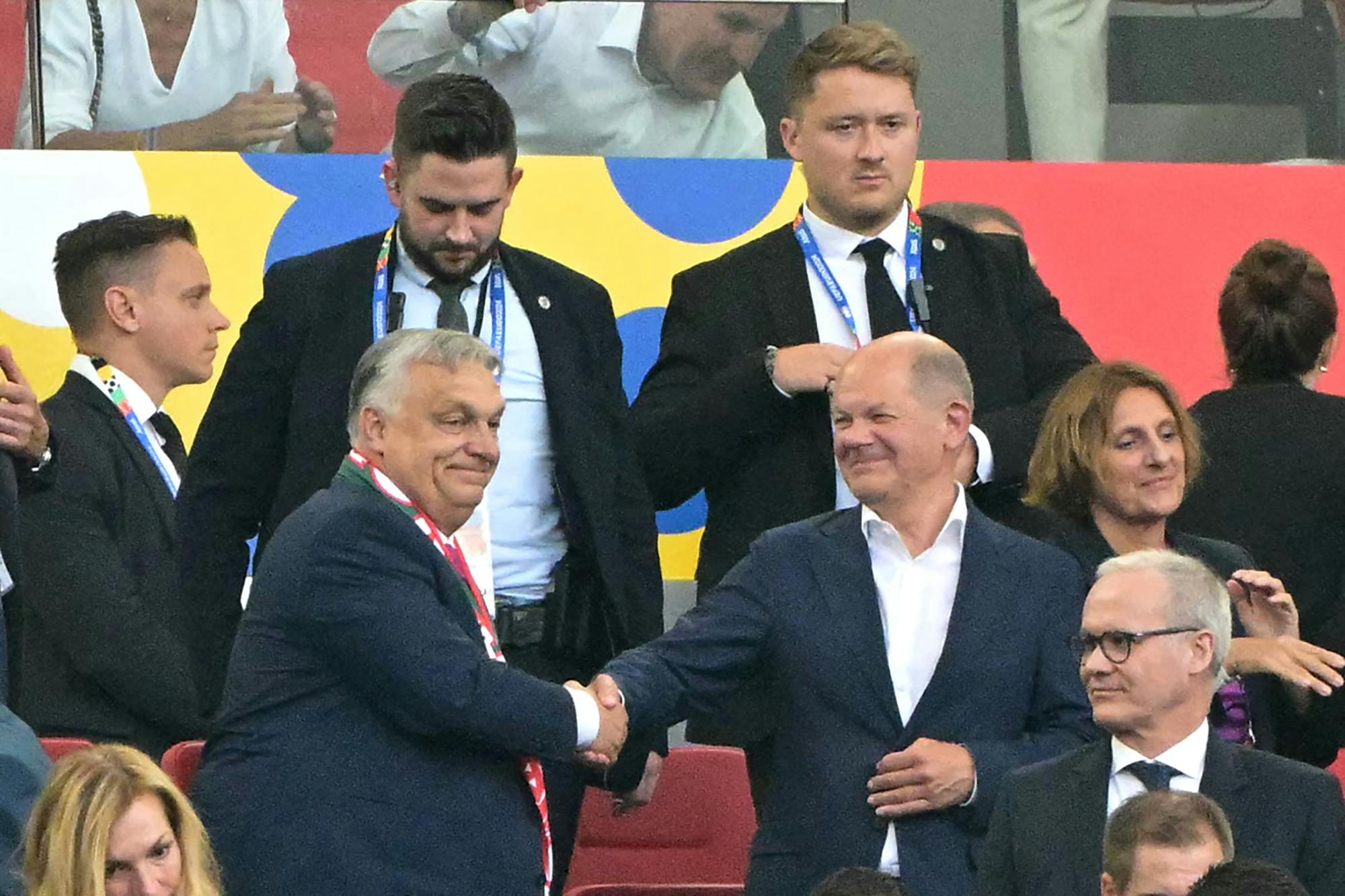 Hungary's Prime Minister Viktor Orban (L) shakes hands with German Chancellor Olaf Scholz after the UEFA Euro 2024 Group A football match between Germany and Hungary at the Stuttgart Arena in Stuttgart on June 19, 2024. (Photo by DAMIEN MEYER / AFP)