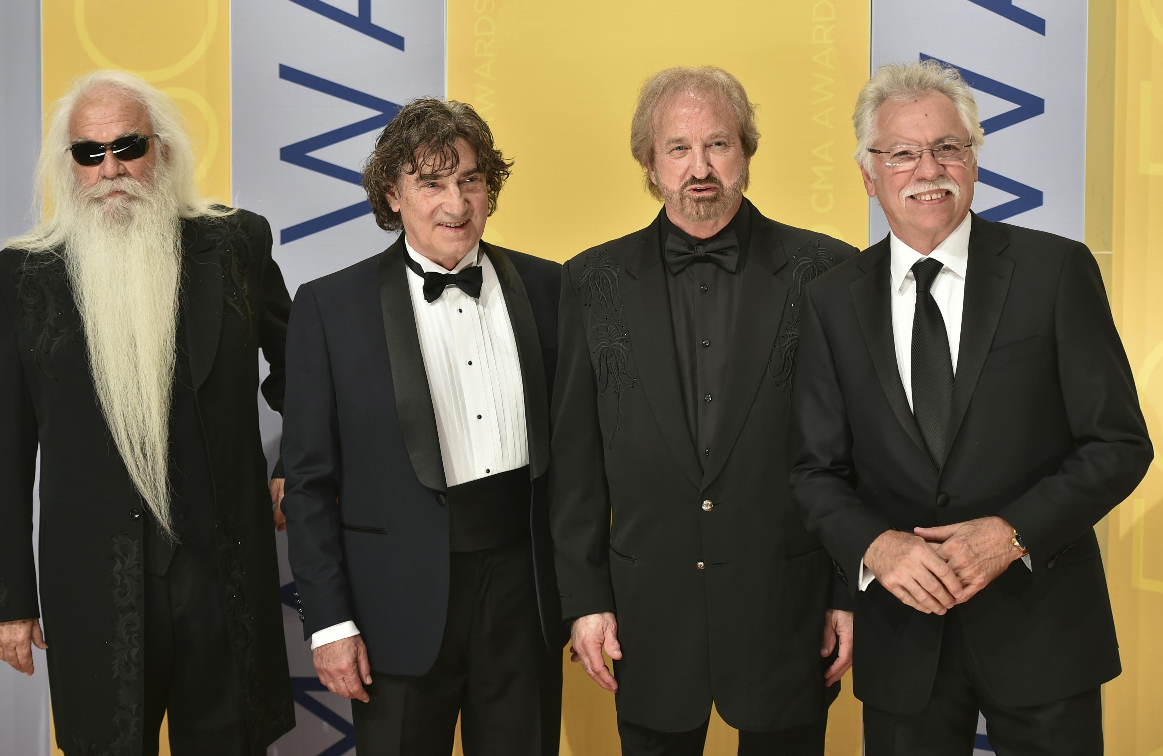 William Lee Golden, from left, Richard Sterban, Duane Allen, and Joe Bonsall of The Oak Ridge Boys arrive at the 50th annual CMA Awards at the Bridgestone Arena on Wednesday, Nov. 2, 2016, in Nashville, Tenn. (Photo by Evan Agostini/Invision/AP)