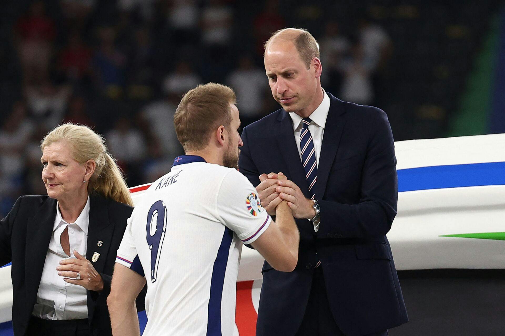 England's forward #09 Harry Kane shakes hands with Britain's Prince William, Prince of Wales after the UEFA Euro 2024 final football match between Spain and England at the Olympiastadion in Berlin on July 14, 2024. (Photo by Adrian DENNIS / AFP)