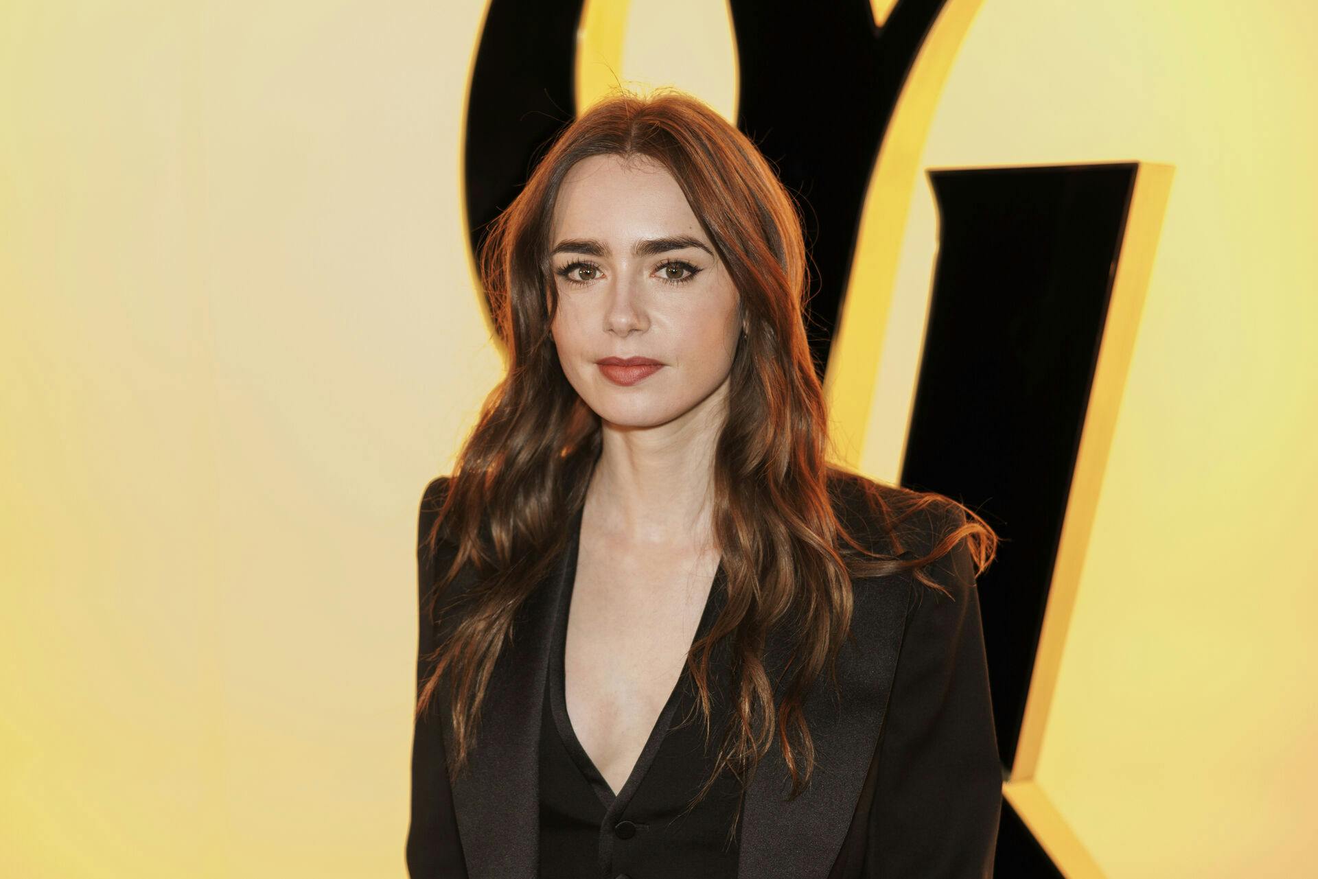 Lily Collins attends the Yves Saint Laurent Fall/Winter 2024-2025 ready-to-wear collection presented Tuesday, Feb. 27, 2024 in Paris. (Photo by Vianney Le Caer/Invision/AP)