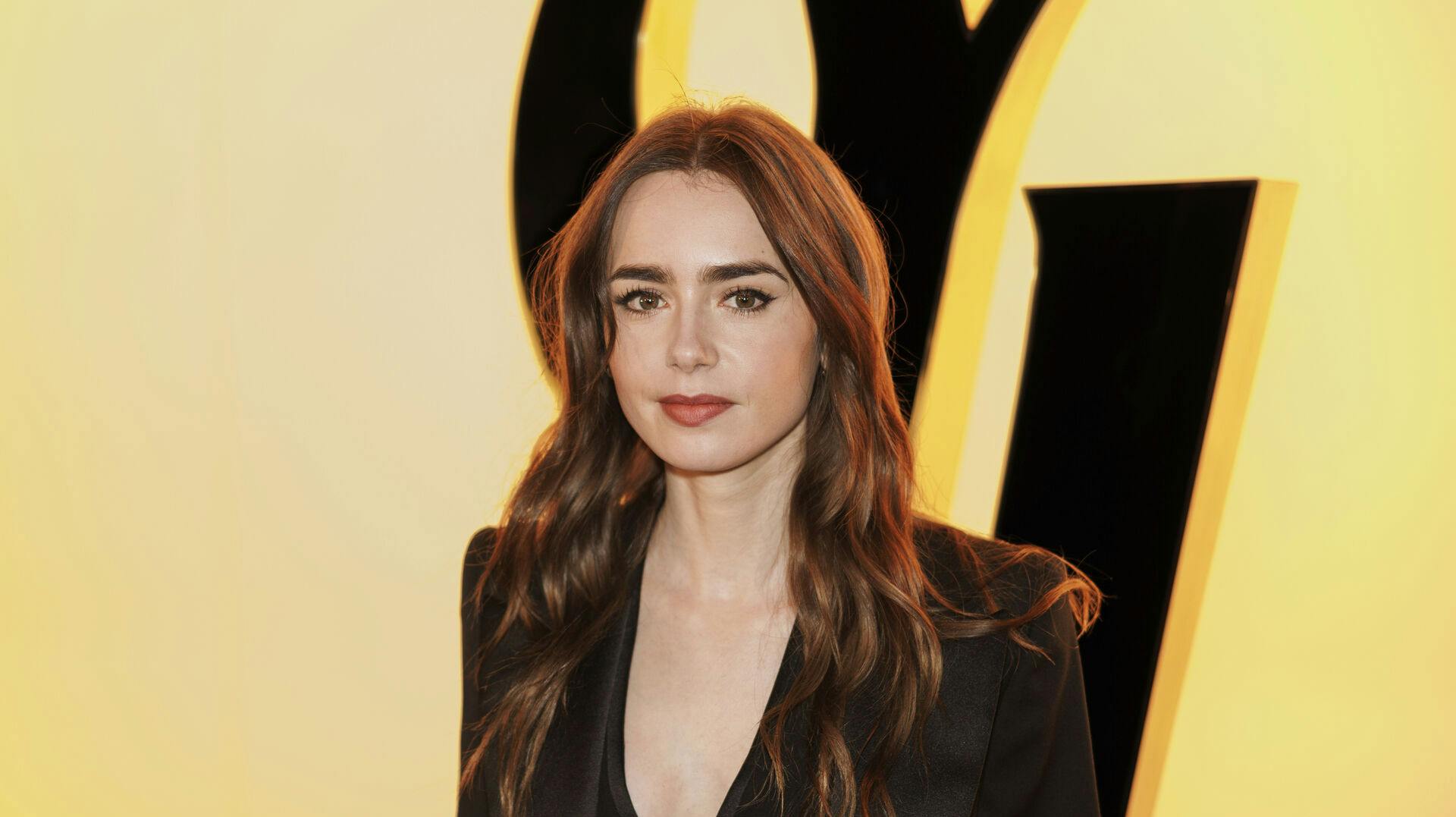 Lily Collins attends the Yves Saint Laurent Fall/Winter 2024-2025 ready-to-wear collection presented Tuesday, Feb. 27, 2024 in Paris. (Photo by Vianney Le Caer/Invision/AP)