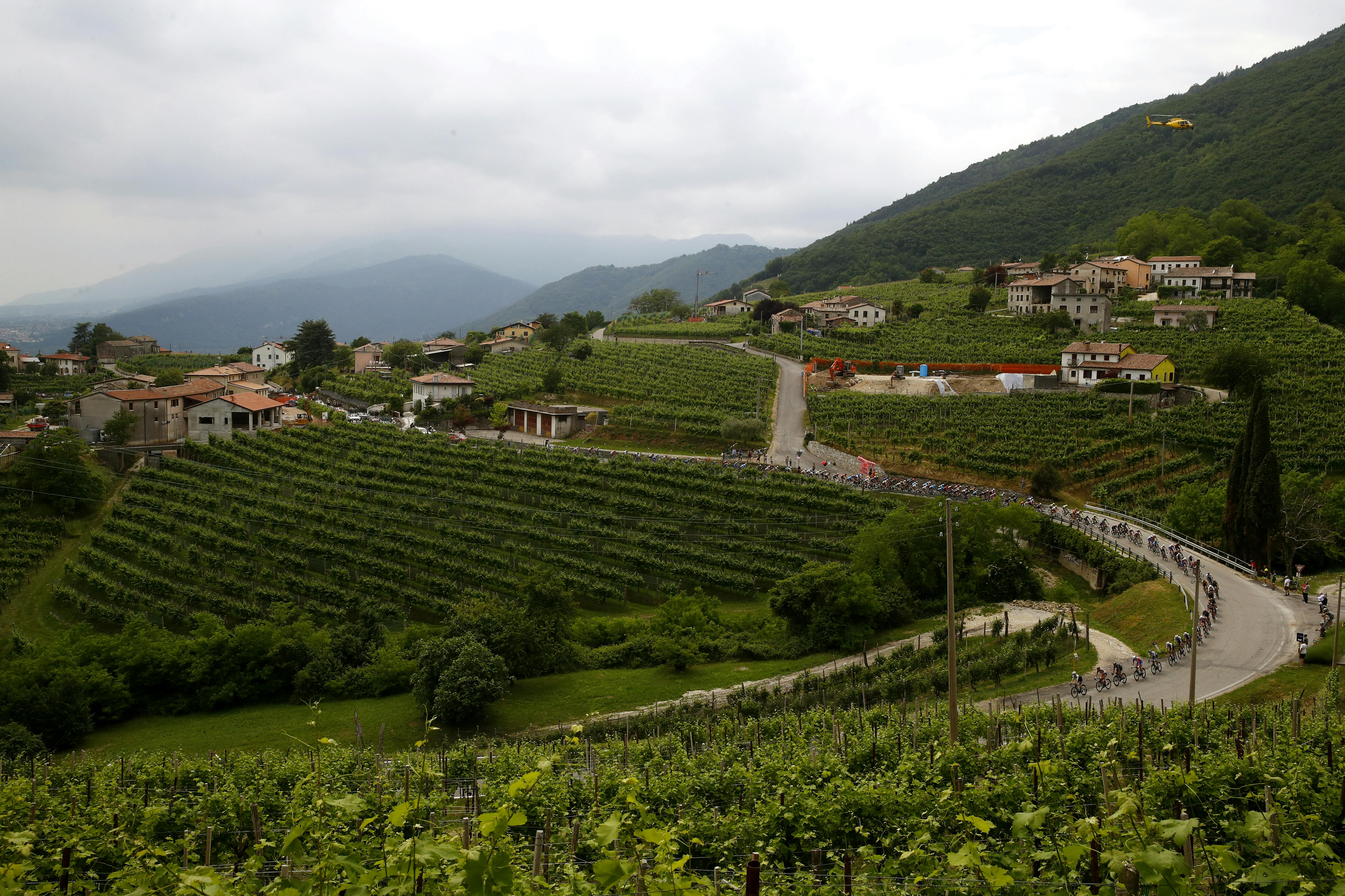 The pack rides near Valdobbiadene during the 18th stage of the Giro d'Italia 2022 cycling race, 156 km from Borgo Valsugana to Treviso, on May 26, 2022. Luca Bettini / AFP