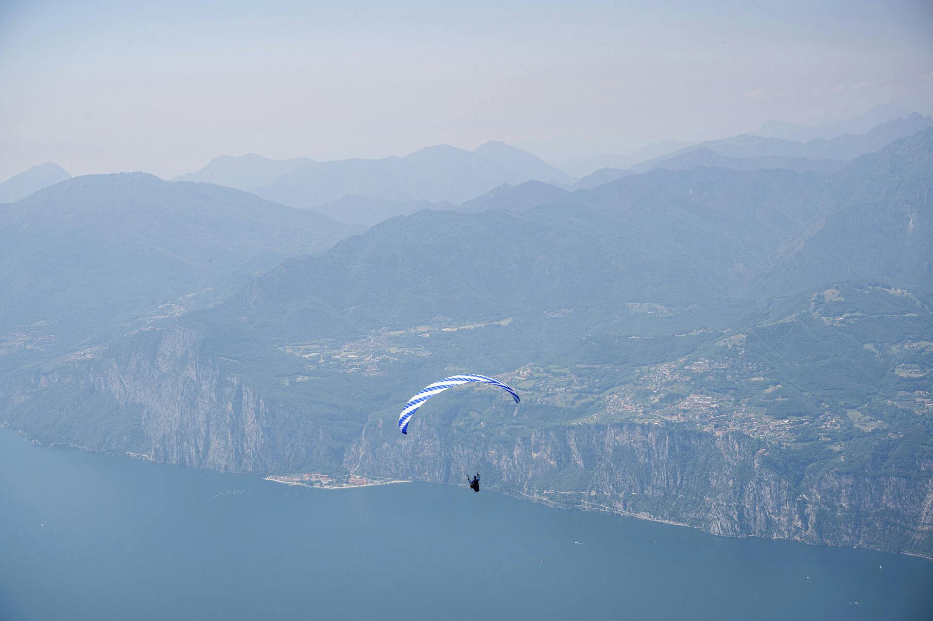 15 June 2021, Italy, Malcesine: View from the mountain Monte Baldo to the Lake Garda, above the water a paraglider is flying. Photo by: Daniel Reinhardt/picture-alliance/dpa/AP Images