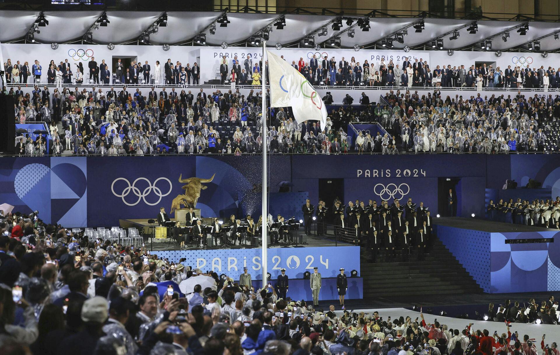 The Olympic flag is hoisted during the opening ceremony of the Paris Olympics in the French capital on July 26, 2024. (Kyodo via AP Images) ==Kyodo
