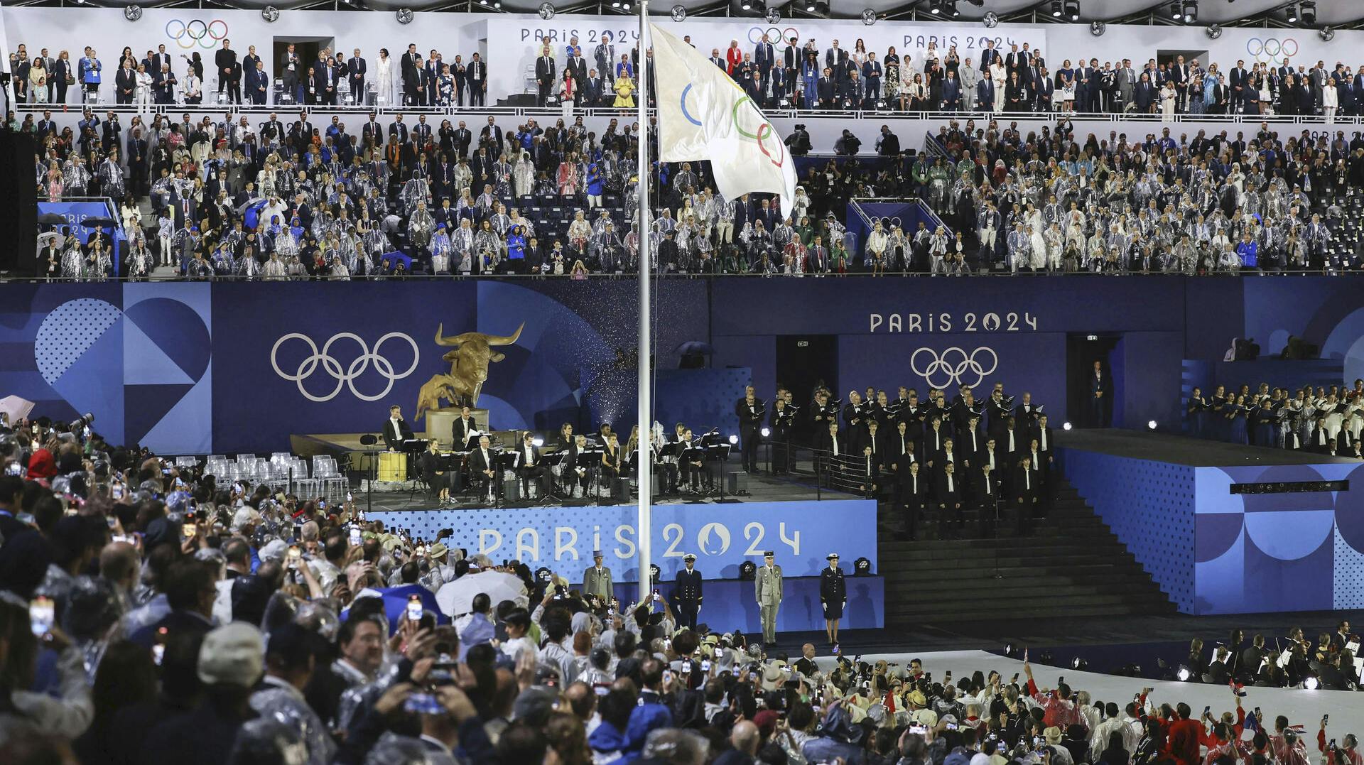 The Olympic flag is hoisted during the opening ceremony of the Paris Olympics in the French capital on July 26, 2024. (Kyodo via AP Images) ==Kyodo