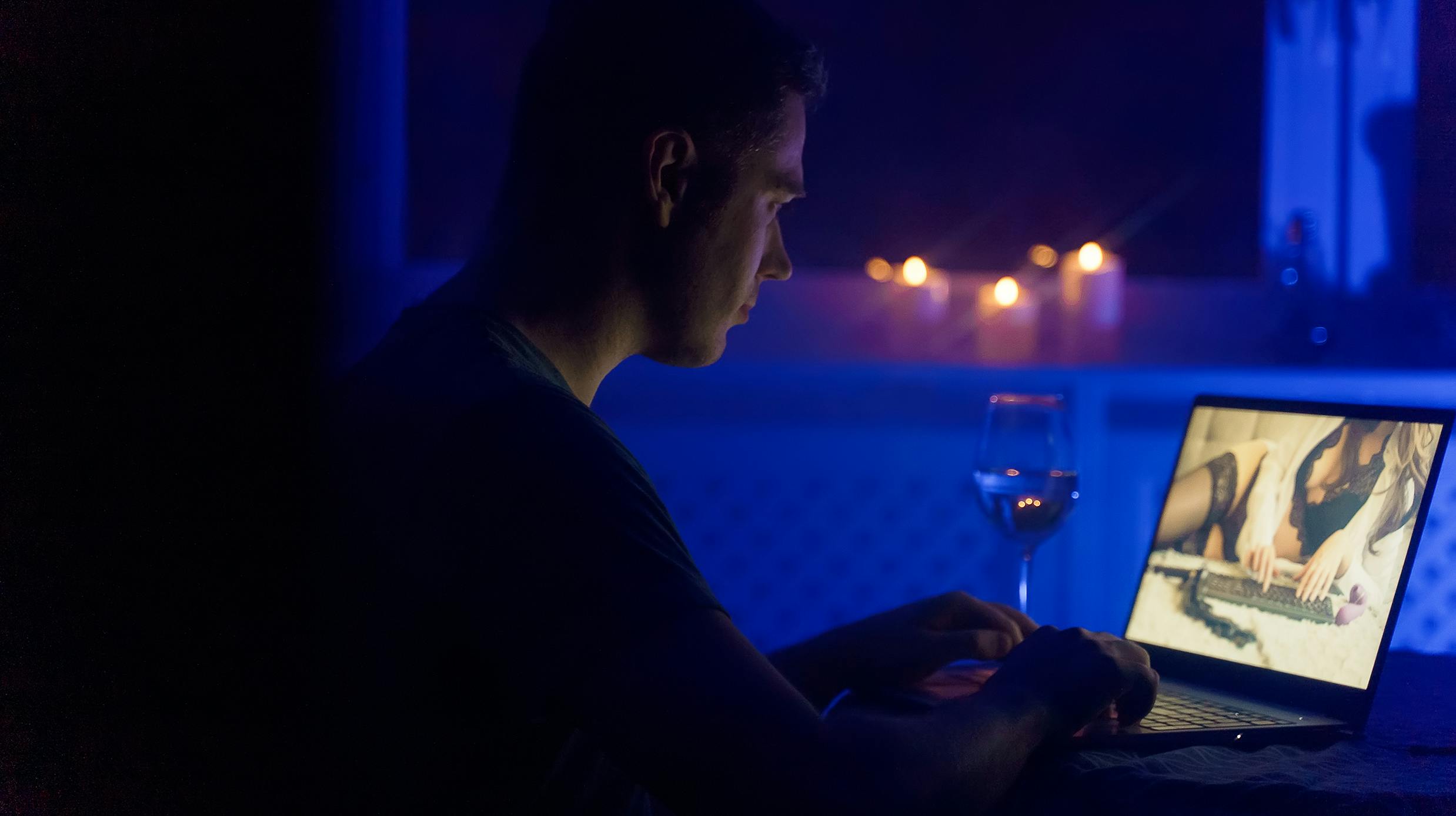 Man chatting with webcam model late at night.