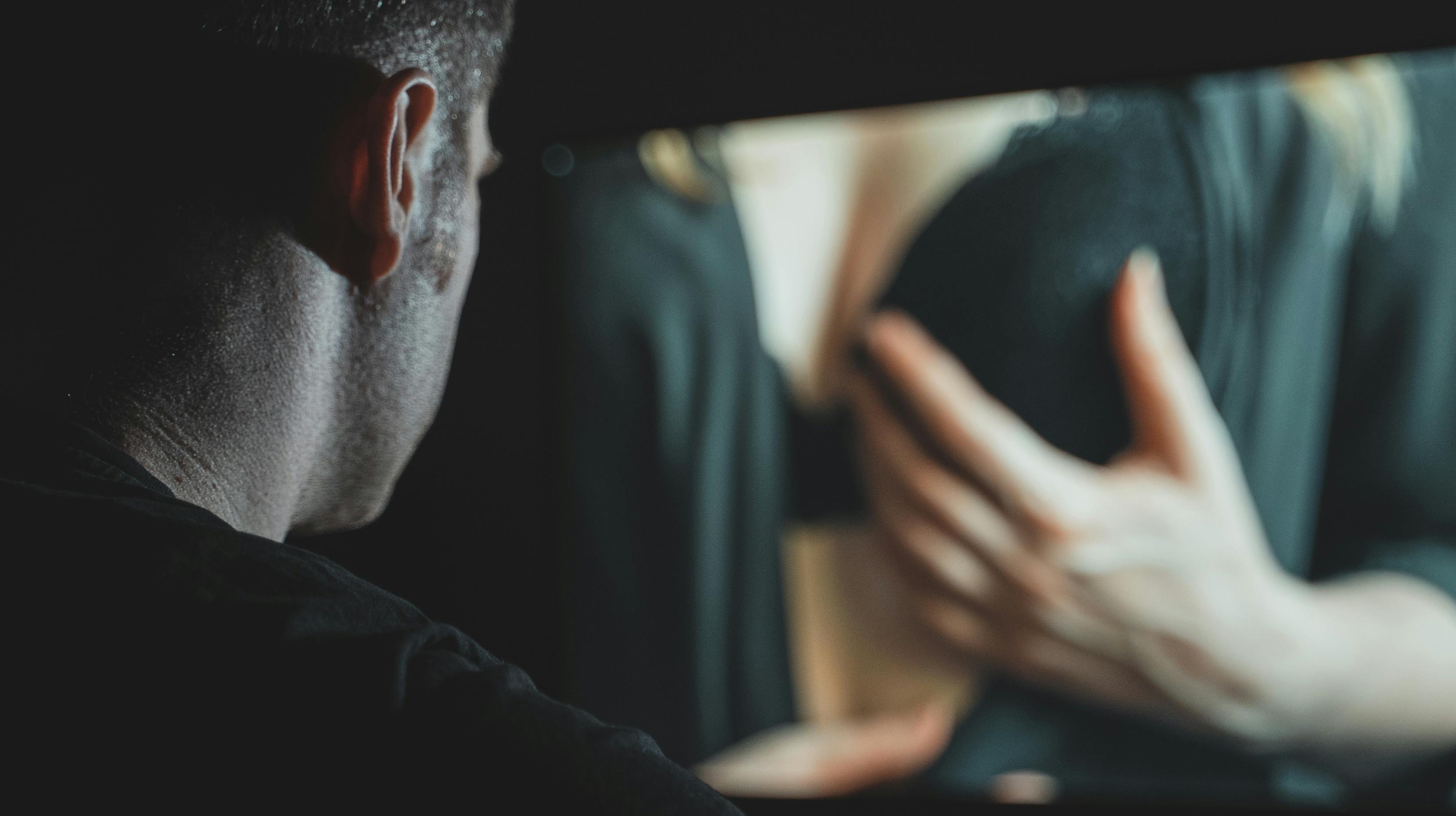 Man watching erotic film late at night.