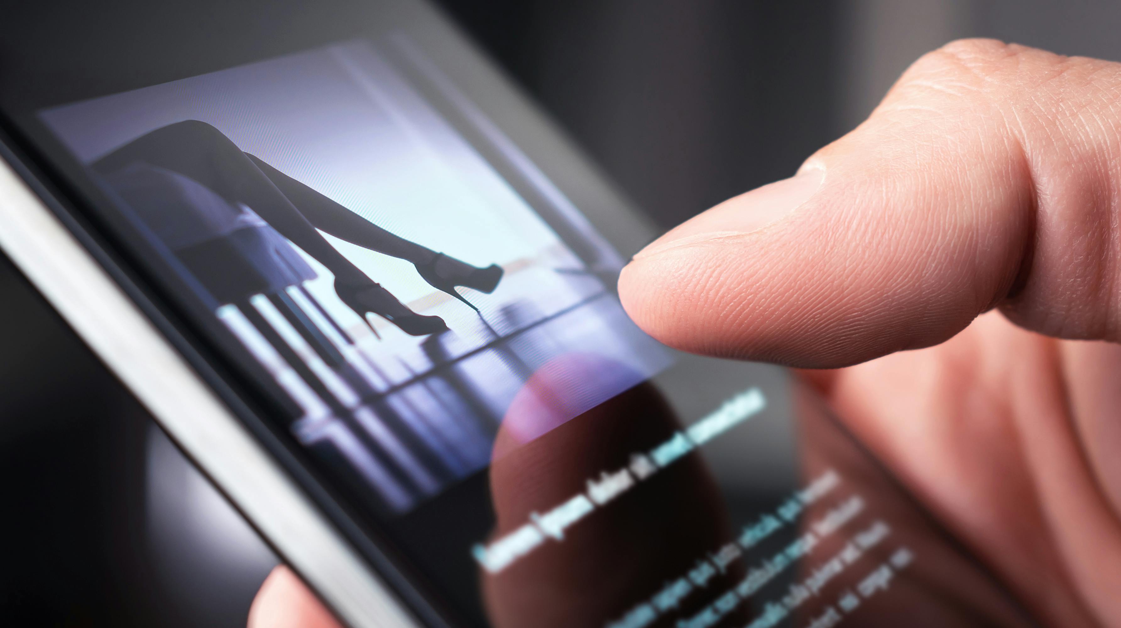 Man watching erotic video or looking at sexy photo with phone. Sex shop or online porn website. Person reading news article about sexual topic. Escort business, strip show or adult content on internet