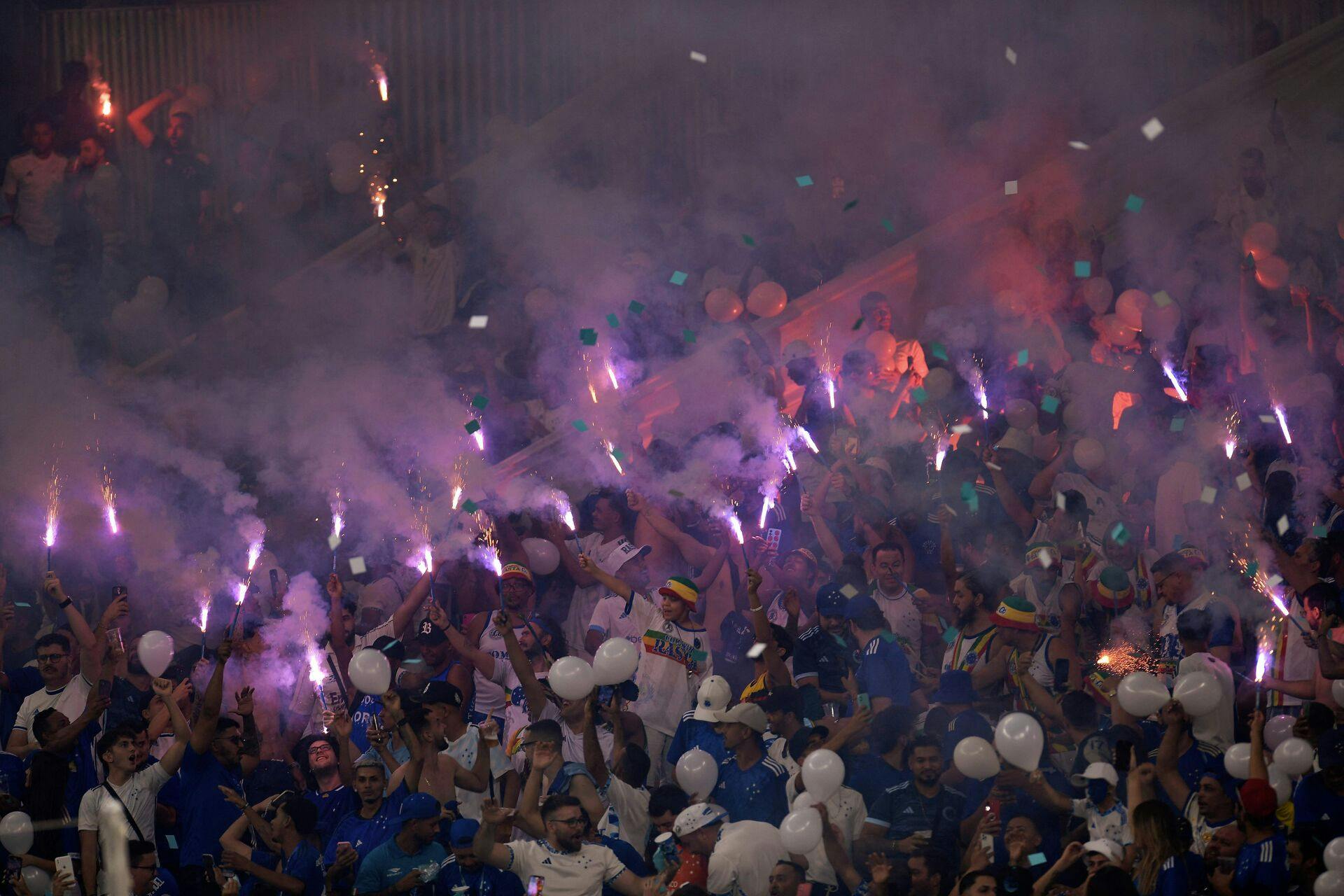 Fans of Cruzeiro cheer for their team before the Copa Sudamericana semi-final first leg football match between Brazil's Cruzeiro and Argentina's Lanus at the Mineirao stadium in Belo Horizonte, Brazil, on October 23, 2024. (Photo by DOUGLAS MAGNO / AFP)