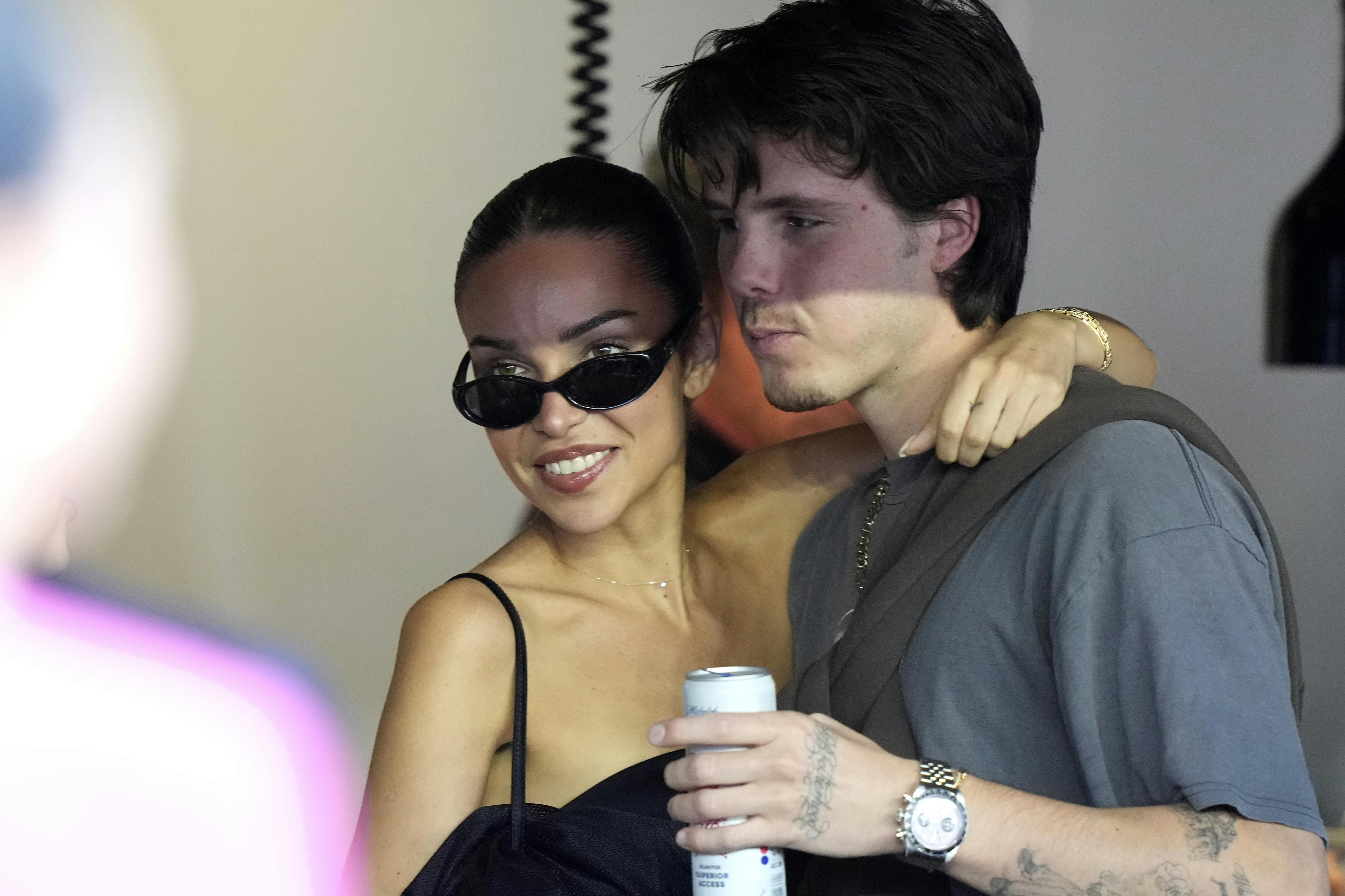 Cruz Beckham, right, stands in a suite with his girlfriend Jackie Apostel, left, before an MLS soccer match between Inter Miami and New England Revolution, Saturday, Oct. 19, 2024, in Fort Lauderdale, Fla. (AP Photo/Lynne Sladky)