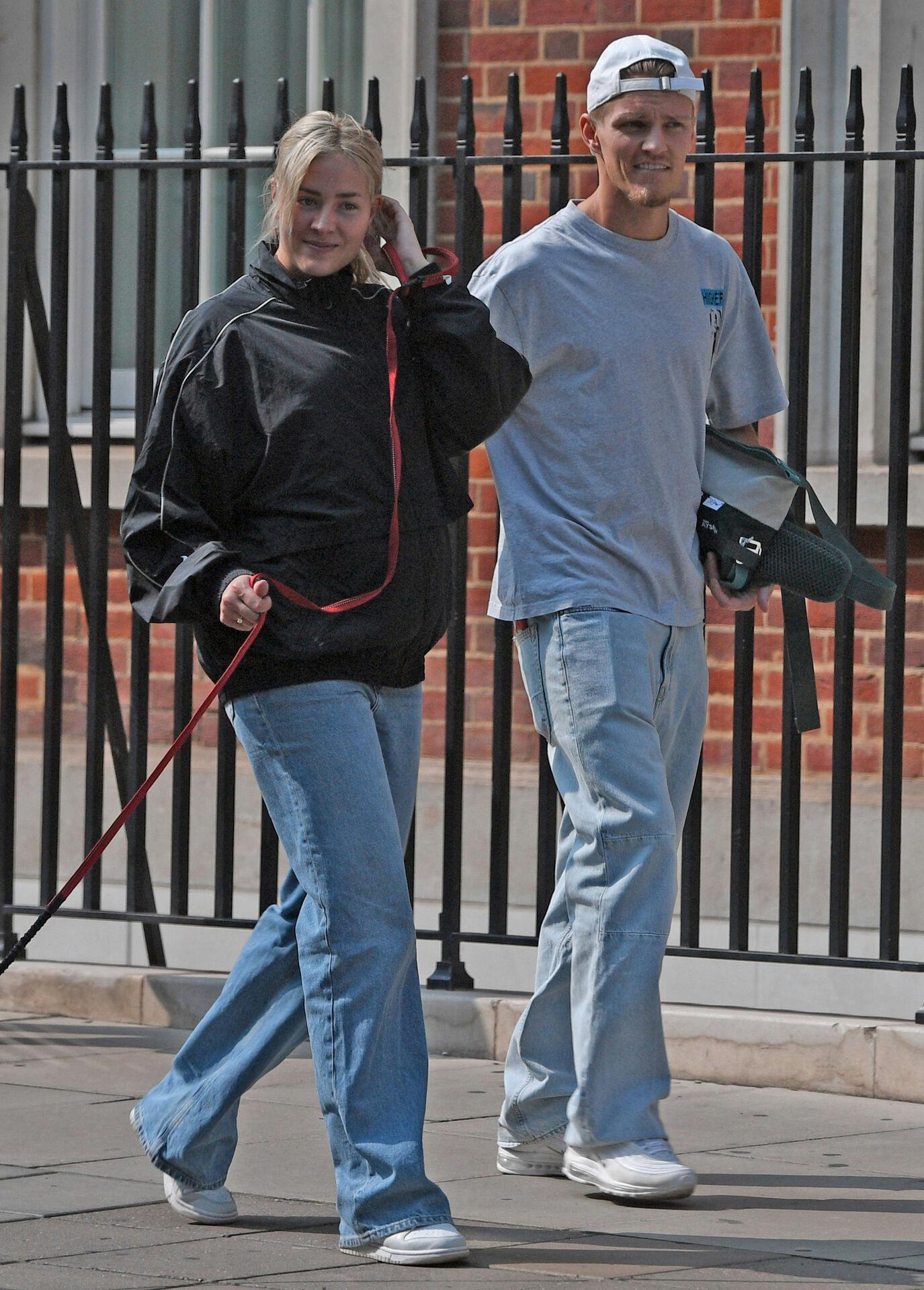 EXCLUSIVE: Arsenal FC midfielder Martin ?degaard and girlfriend Helene Spilling were seen enjoying a romantic dog walk in London. Helene was spotted wearing a gold band on her engagement ring finger, sparking speculation about their engagement. Pictured: martin odegaard, helene spilling Ref: BLU_S7865536 180824 EXCLUSIVE Picture by: / SplashNews.com Splash News and Pictures USA: 310-525-5808 UK: 020 8126 1009 eamteam@shutterstock.com World Rights