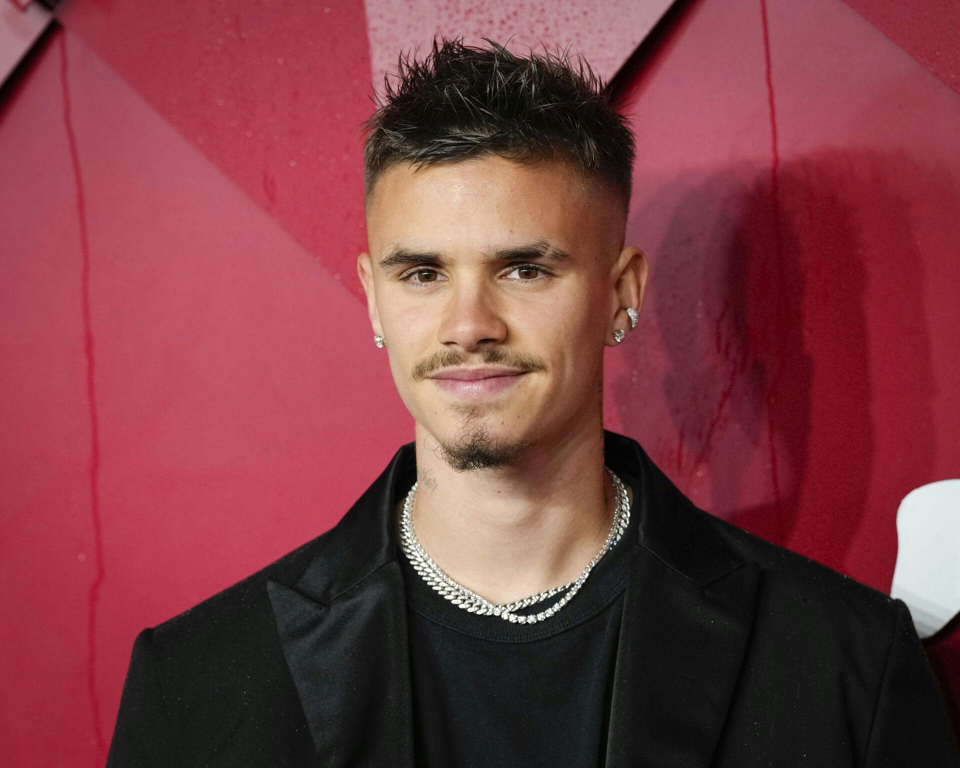 Romeo Beckham poses for photographers upon arrival at the British Fashion Awards on Monday, Dec. 4, 2023 in London. (Scott Garfitt/Invision/AP)