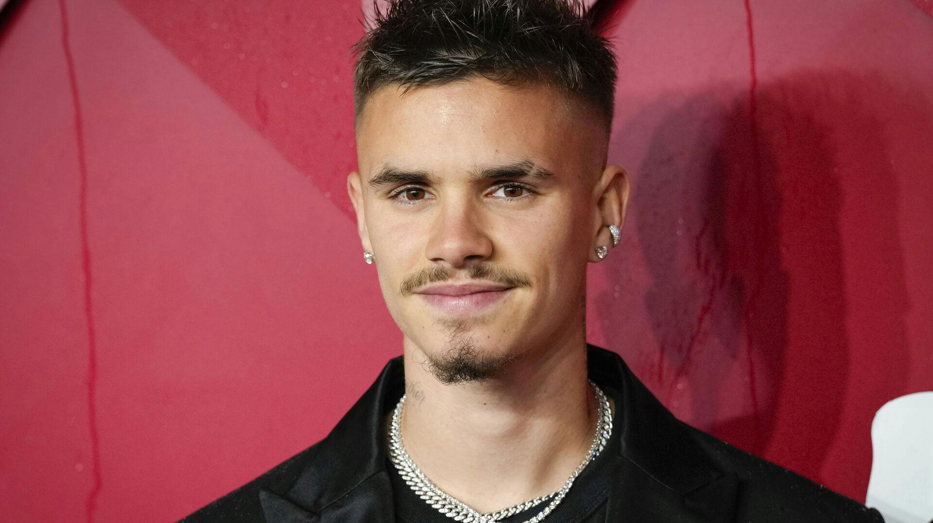Romeo Beckham poses for photographers upon arrival at the British Fashion Awards on Monday, Dec. 4, 2023 in London. (Scott Garfitt/Invision/AP)
