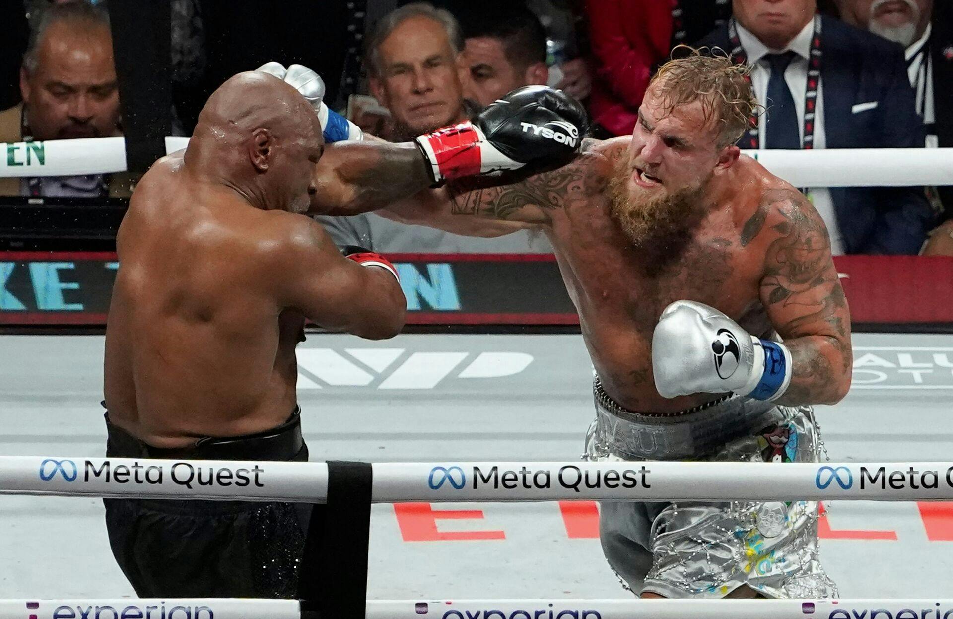 US retired pro-boxer Mike Tyson (L) and US YouTuber/boxer Jake Paul (R) fight during the heavyweight boxing bout at The Pavilion at AT&T Stadium in Arlington, Texas, November 15, 2024. (Photo by TIMOTHY A. CLARY / AFP)