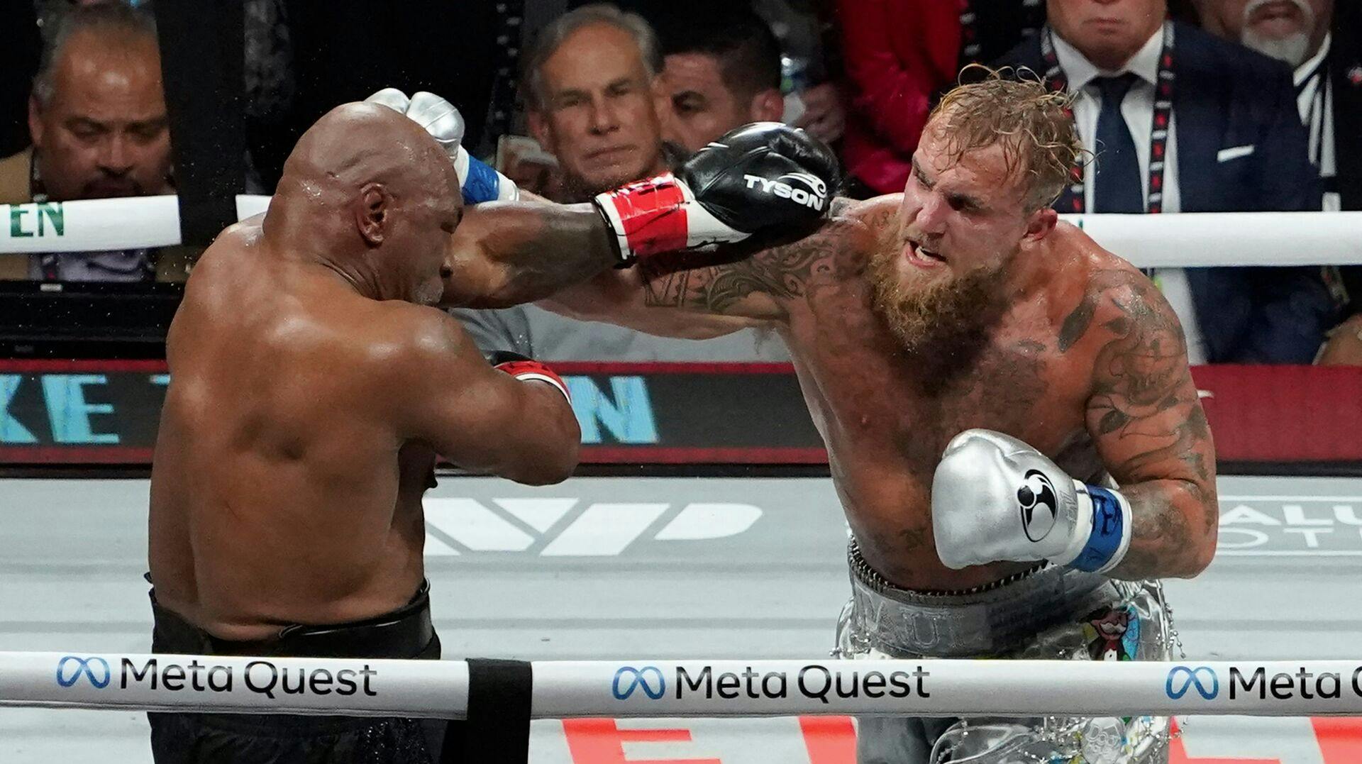 US retired pro-boxer Mike Tyson (L) and US YouTuber/boxer Jake Paul (R) fight during the heavyweight boxing bout at The Pavilion at AT&T Stadium in Arlington, Texas, November 15, 2024. (Photo by TIMOTHY A. CLARY / AFP)