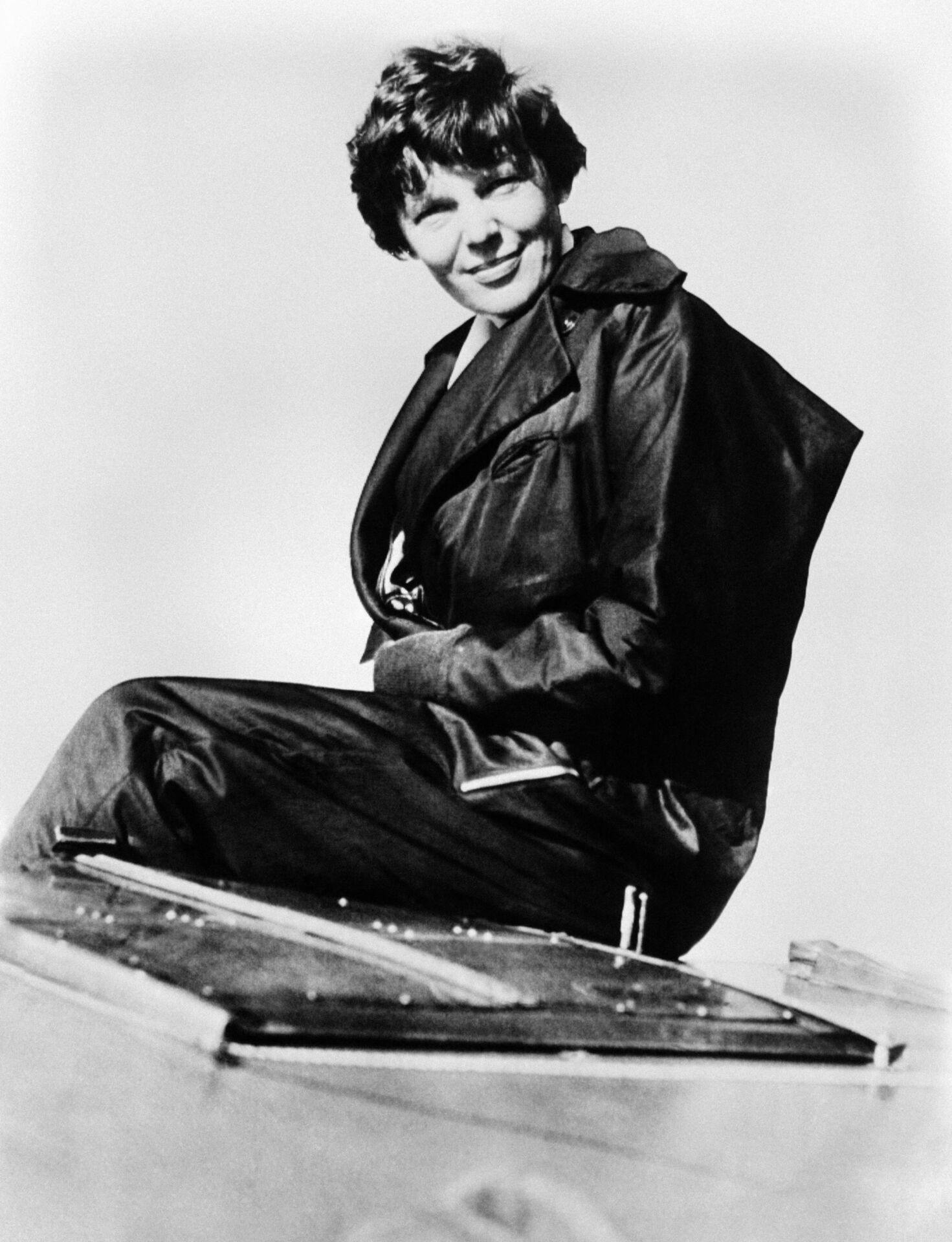 US aviator Amelia Earhart poses on her high wing monoplane, on November 01, 1935 in San Francisco before it was shipped to hawaiian Islands from California. US Amelia Earhart was a aviation pioneer and writer, the first woman to fly the Atlantic as a passenger, in 1928, and the first female aviator to fly solo across the Atlantic Ocean in 1932. She disappeared over the Pacific on July 2, 1937 with Fred Noonan, while they were undertaking a world tour. AFP