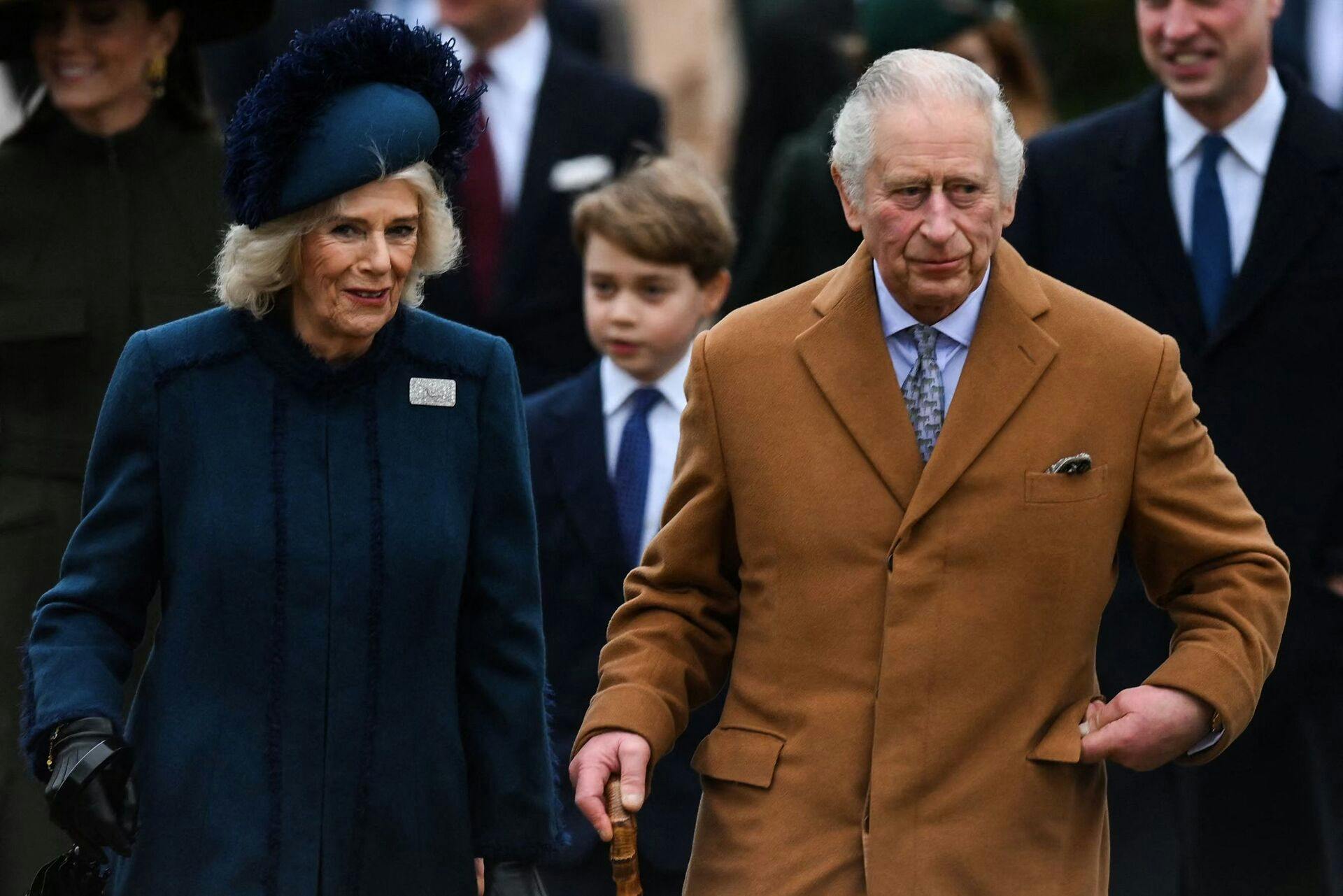 Britain's King Charles III (R) and Britain's Camilla, Queen Consort (L) arrive for the Royal Family's traditional Christmas Day service at St Mary Magdalene Church in Sandringham, Norfolk, eastern England, on December 25, 2022. (Photo by Daniel LEAL / AFP)