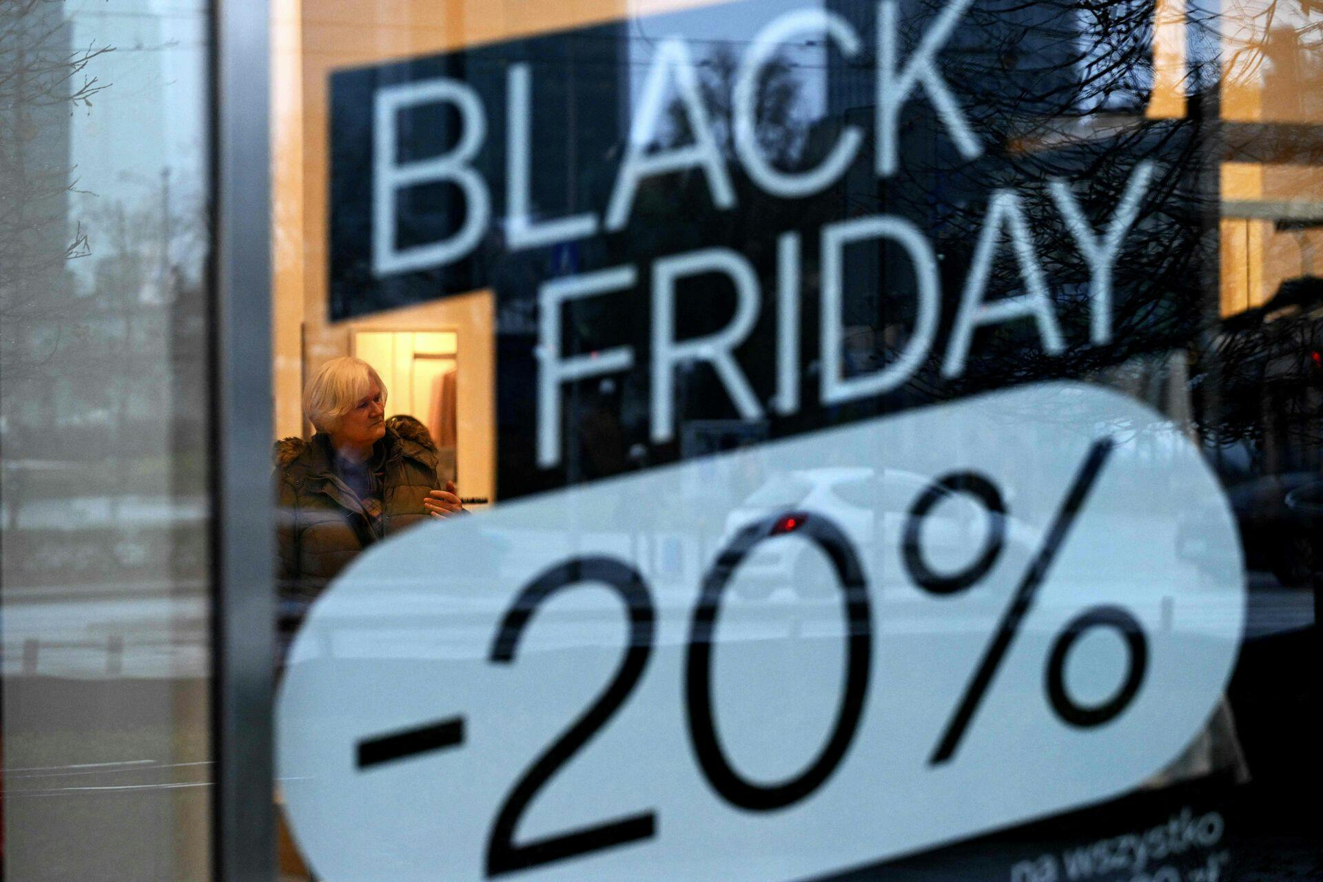 A woman visits a C&A clothing shop promoting Black Friday sales in Warsaw on November 28, 2024. (Photo by Sergei GAPON / AFP)