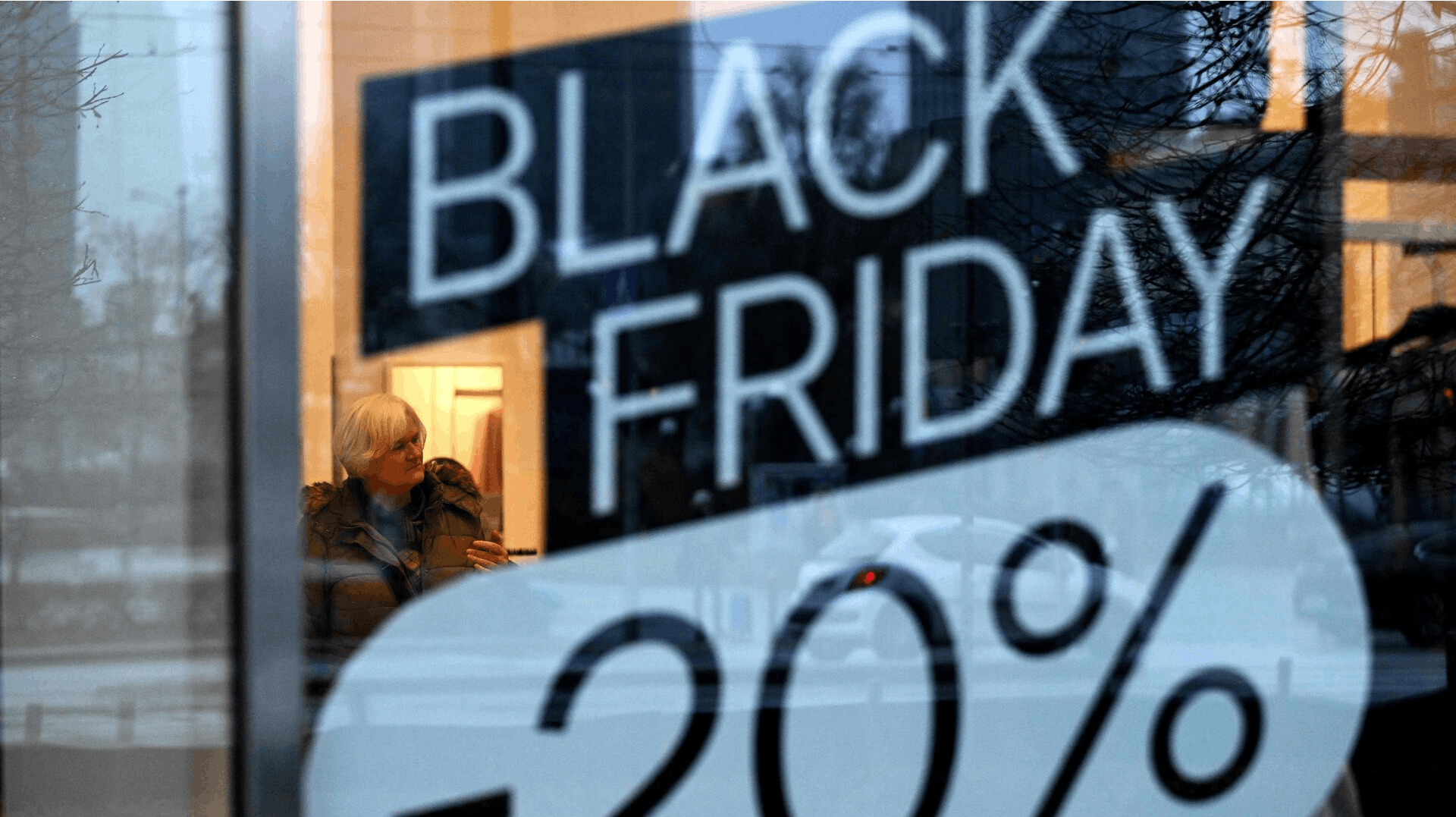 A woman visits a C&A clothing shop promoting Black Friday sales in Warsaw on November 28, 2024. (Photo by Sergei GAPON / AFP)