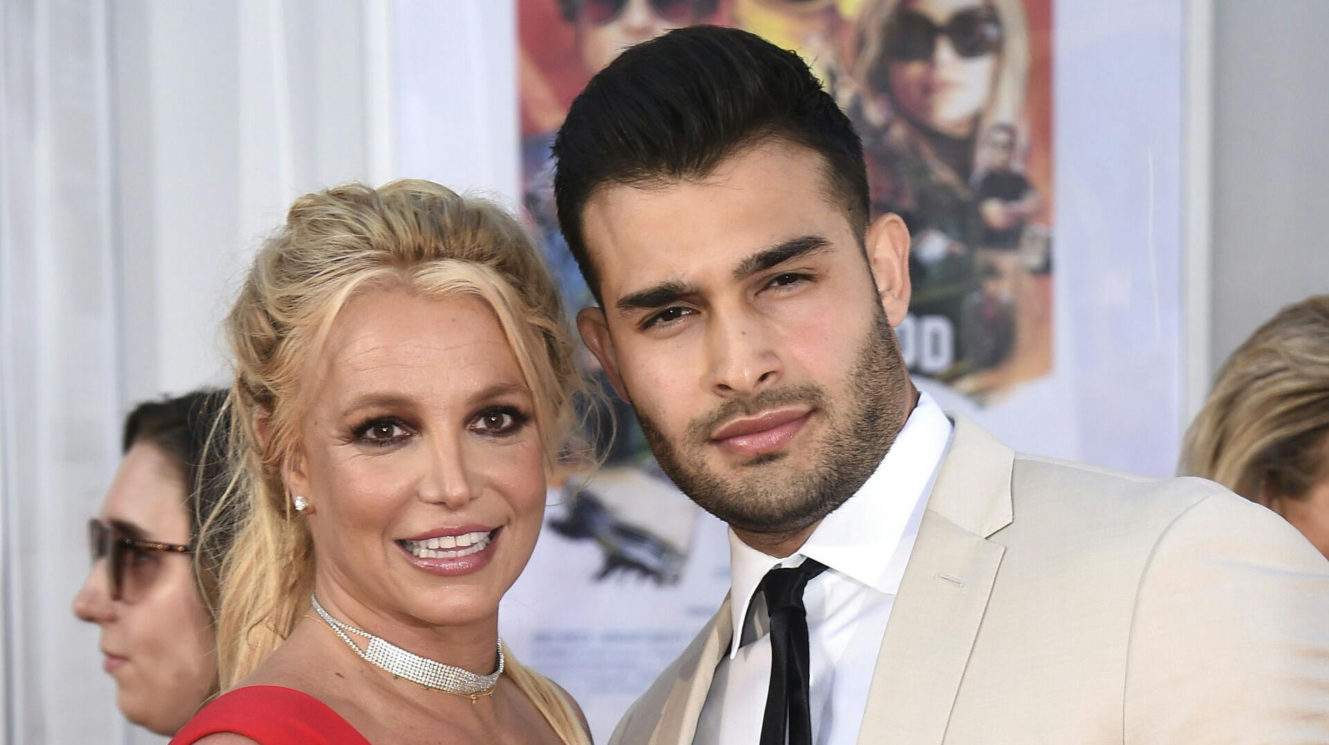 FILE - Britney Spears and Sam Asghari appear at the Los Angeles premiere of "Once Upon a Time in Hollywood" on July 22, 2019. Spears has reached a divorce settlement with her soon-to-be-ex-husband Asghari. (Photo by Jordan Strauss/Invision/AP, File)