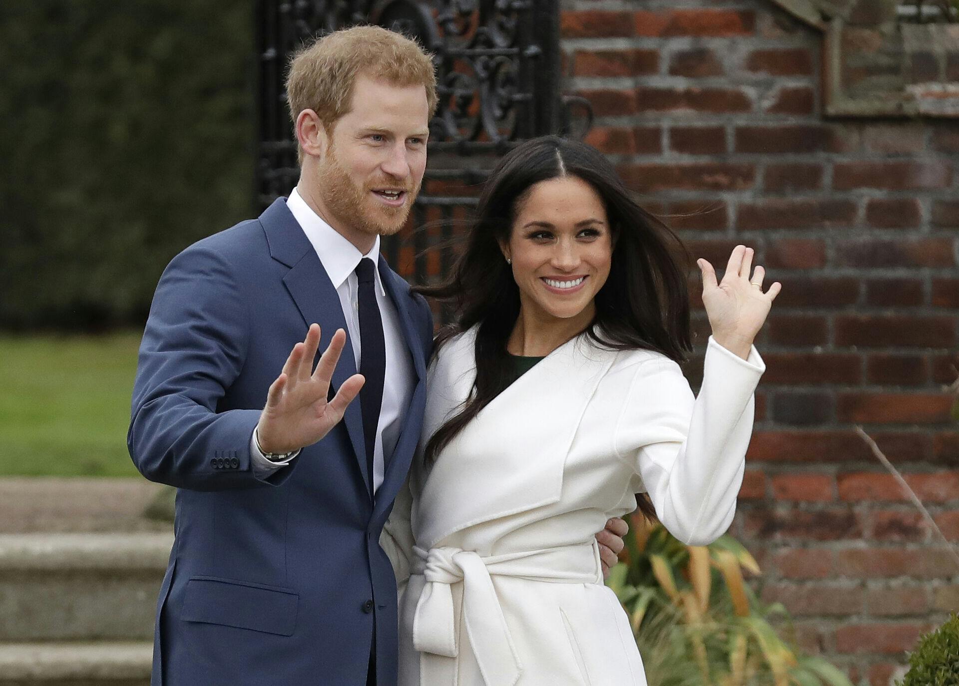 FILE - Britain's Prince Harry and his fiancee Meghan Markle pose for photographers during a photocall in the grounds of Kensington Palace in London, Monday Nov. 27, 2017. (AP Photo/Matt Dunham, File)