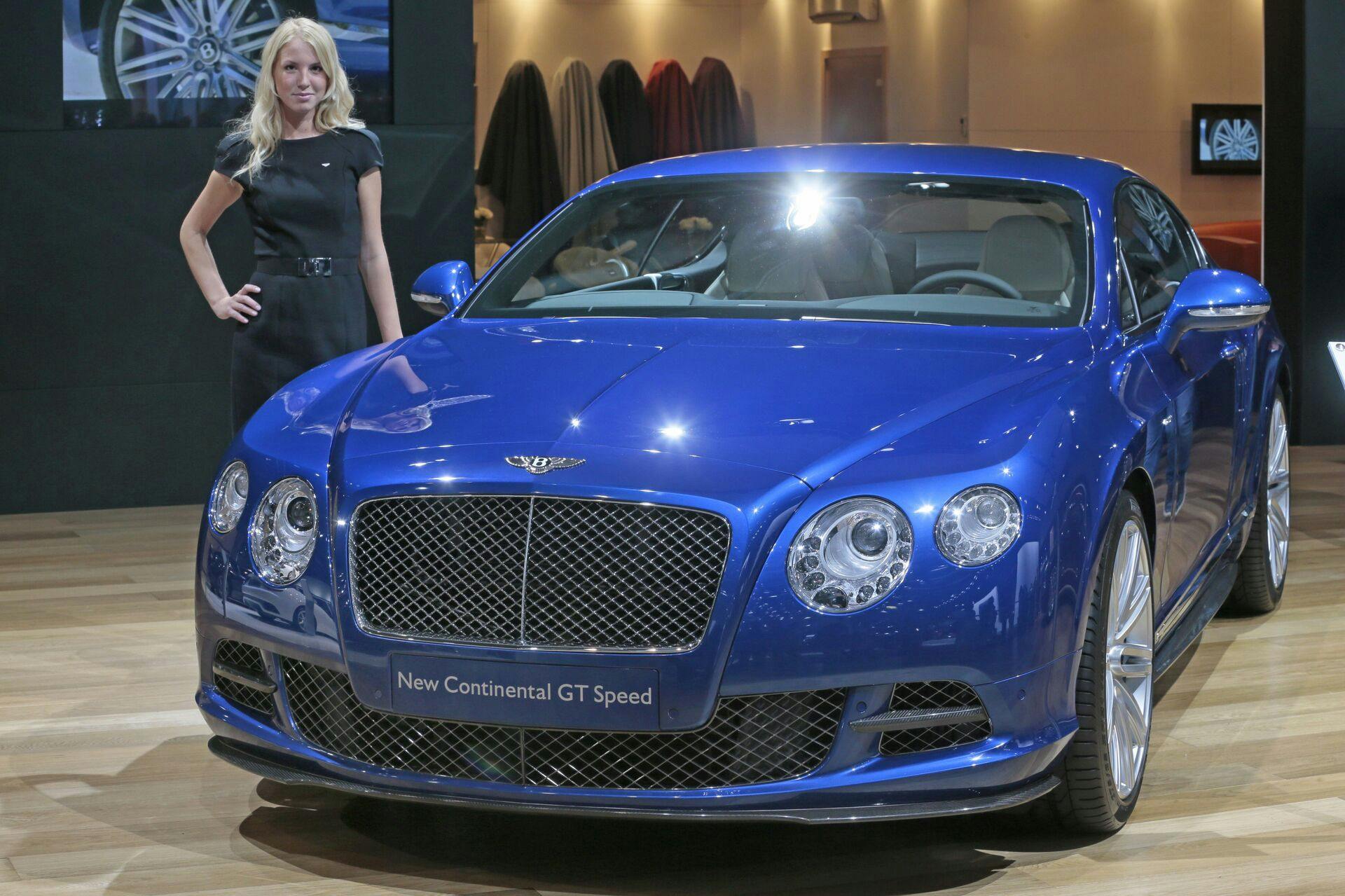 A model stands at Bentley Continental GT Speed car at the Moscow International Automobile Salon in Moscow, Russia, Friday, Aug. 31, 2012. (AP Photo/Mikhail Metzel)