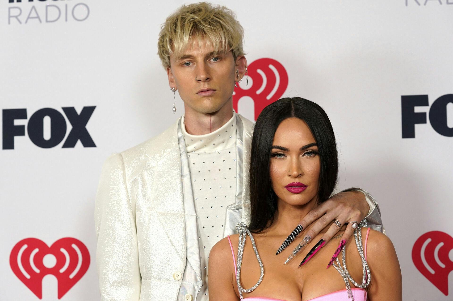 FILE - Megan Fox, right, and Machine Gun Kelly attend the iHeartRadio Music Awards on May 27, 2021, in Los Angeles. (AP Photo/Chris Pizzello, File)