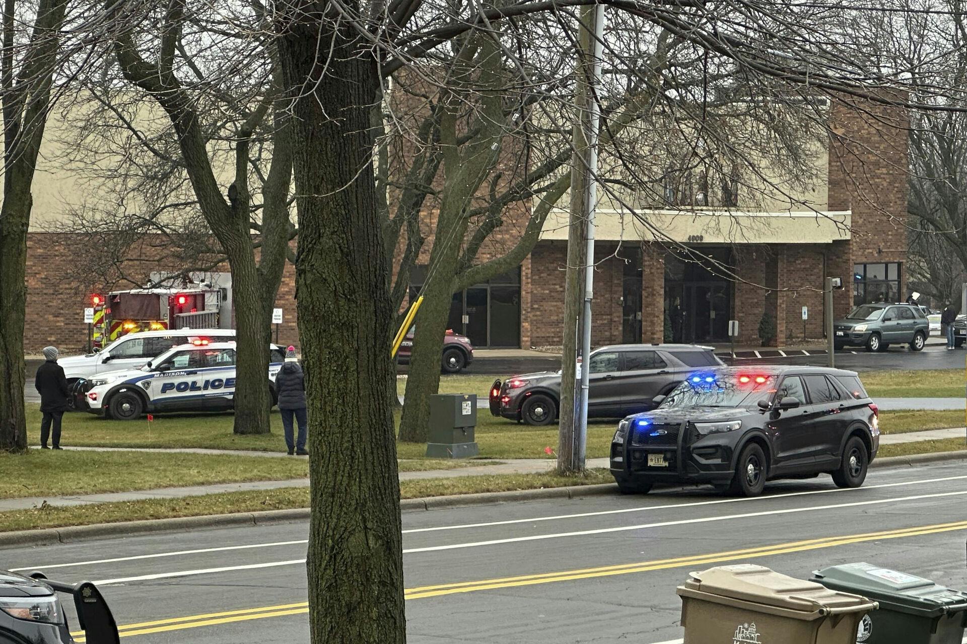 Emergency vehicles are parked outside the Abundant Life Christian School in Madison, Wis., where multiple injuries were reported following a shooting, Monday, Dec. 16, 2024. (AP Photo/Scott Bauer)