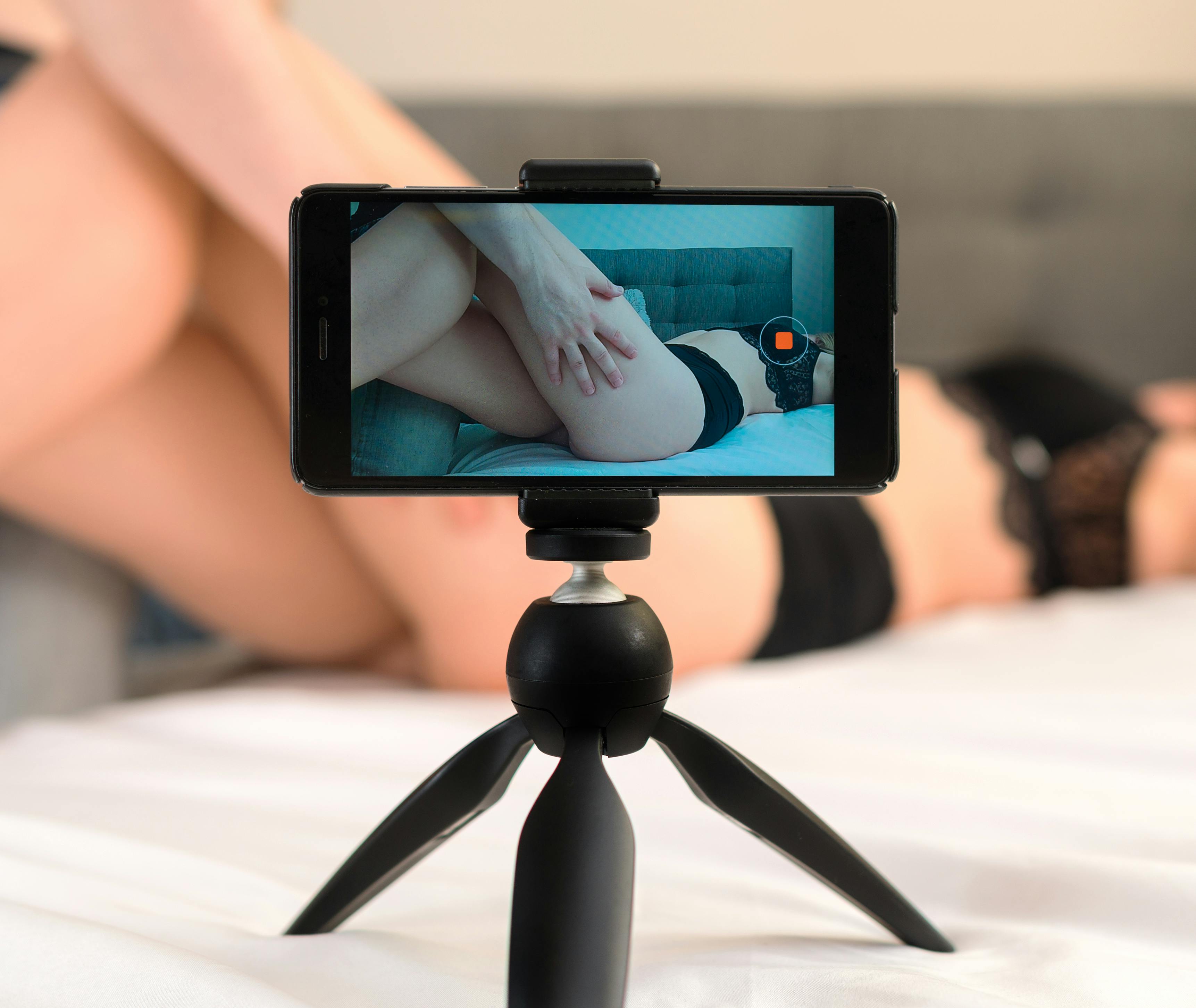 Couple recording their adult video on mobile phone.