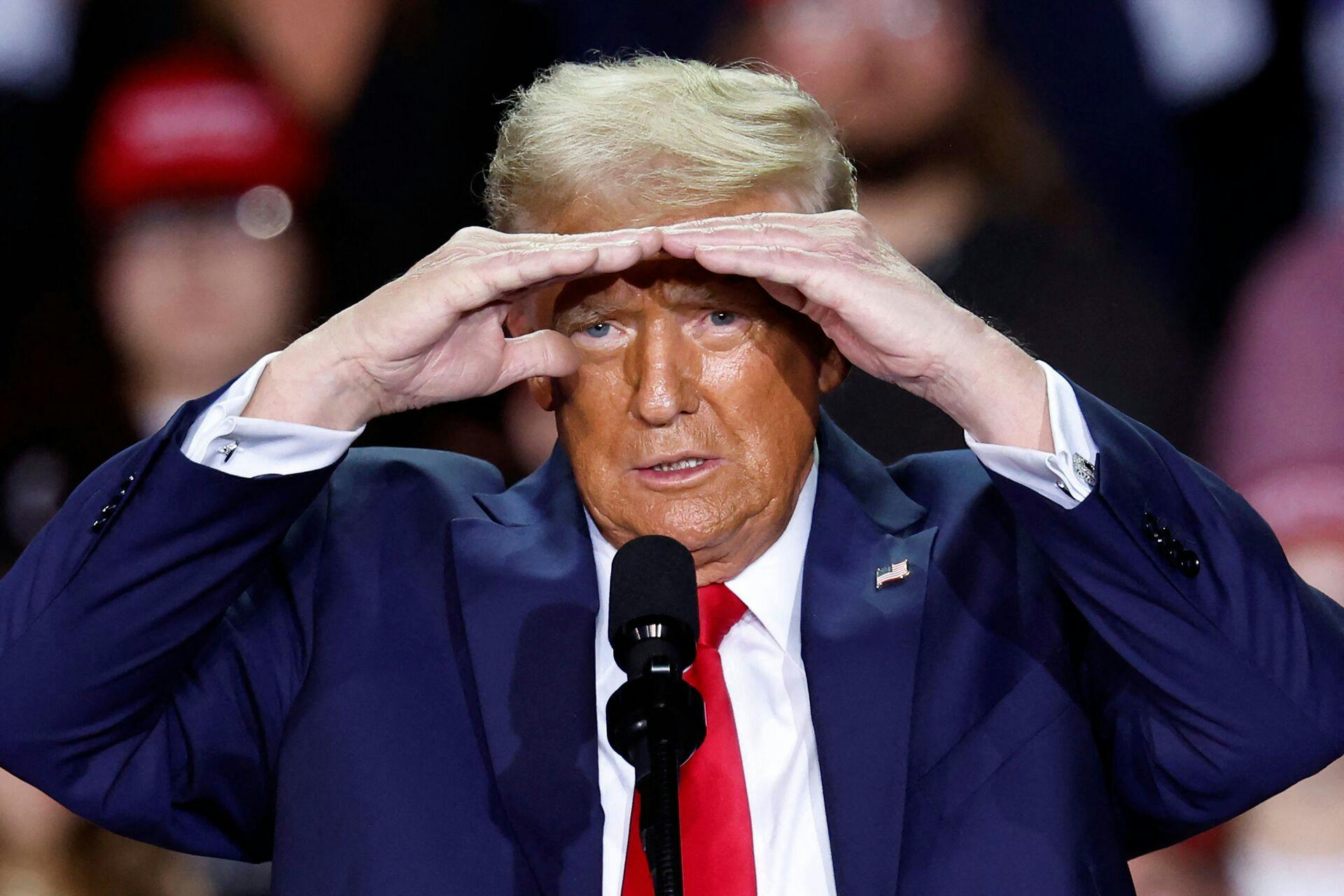 TOPSHOT - Former US President and Republican presidential candidate Donald Trump gestures as he speaks during a campaign rally at Van Andel Arena in Grand Rapids, Michigan on November 5, 2024. (Photo by KAMIL KRZACZYNSKI / AFP)