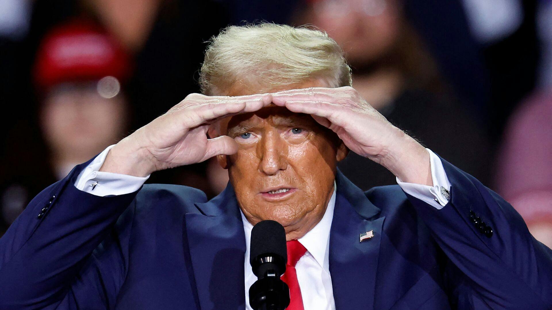 TOPSHOT - Former US President and Republican presidential candidate Donald Trump gestures as he speaks during a campaign rally at Van Andel Arena in Grand Rapids, Michigan on November 5, 2024. (Photo by KAMIL KRZACZYNSKI / AFP)