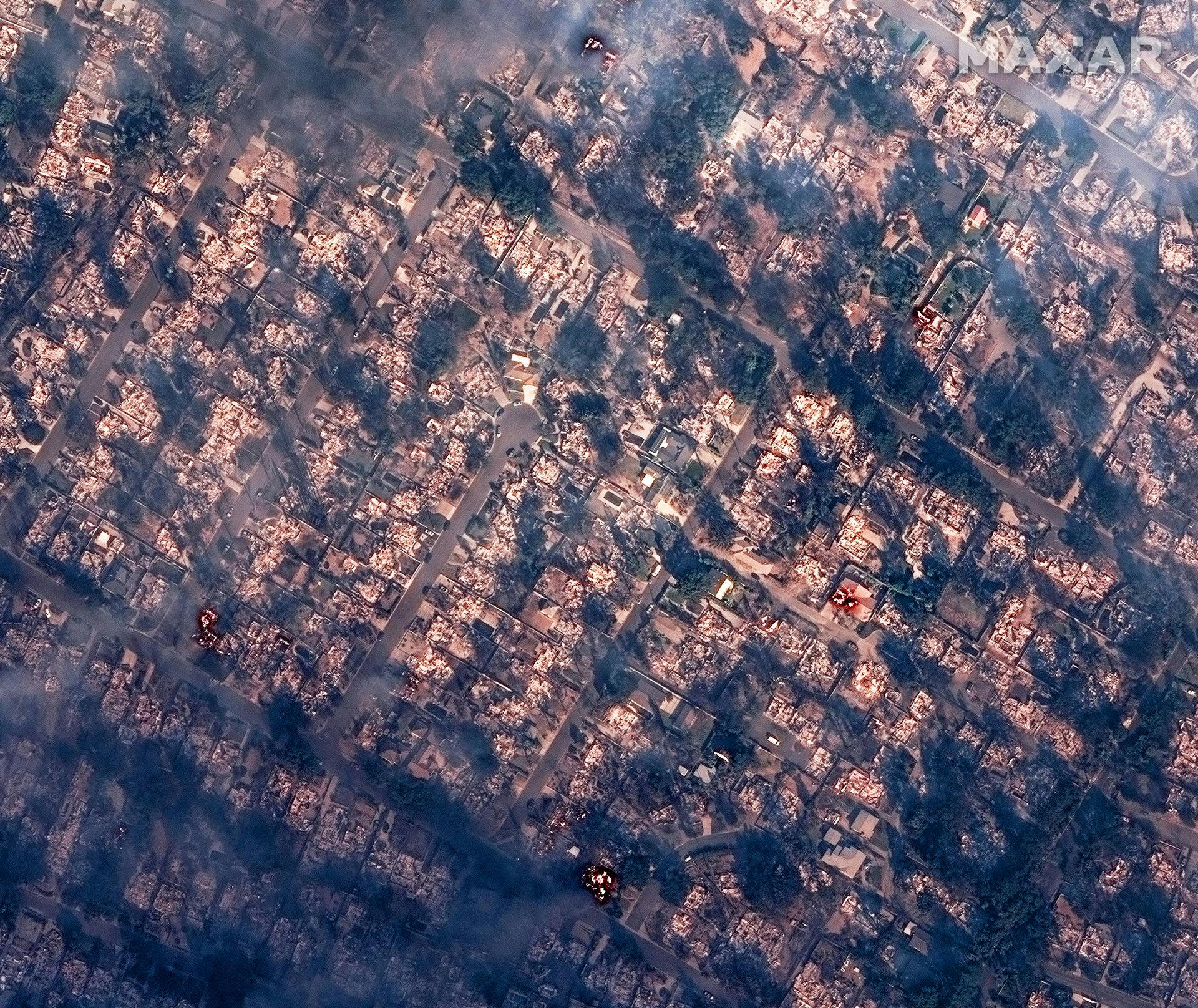 A satellite image shows smoke covering houses after devastating wildfires, in Altadena, California, U.S., January 8, 2025. Maxar Technologies/Handout via REUTERS NO RESALES.NO ARCHIVES. THIS IMAGE HAS BEEN SUPPLIED BY A THIRD PARTY. MANDATORY CREDIT. MUST NOT OBSCURE LOGO. SEARCH "CALIFORNIA WILDFIRES" FOR THIS STORY. SEARCH "WIDER IMAGE" FOR ALL STORIES. TPX IMAGES OF THE DAY