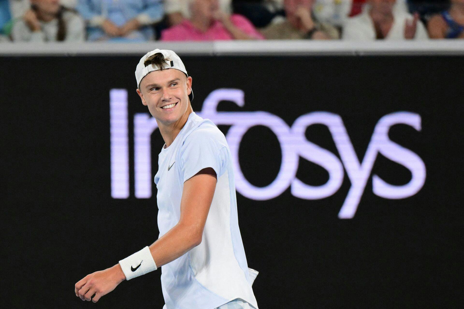 Denmark's Holger Rune reacts on a point against Serbia's Miomir Kecmanovic during their men's singles match on day seven of the Australian Open tennis tournament in Melbourne on January 18, 2025. (Photo by Yuichi YAMAZAKI / AFP) / - - IMAGE RESTRICTED TO EDITORIAL USE - STRICTLY NO COMMERCIAL USE - -