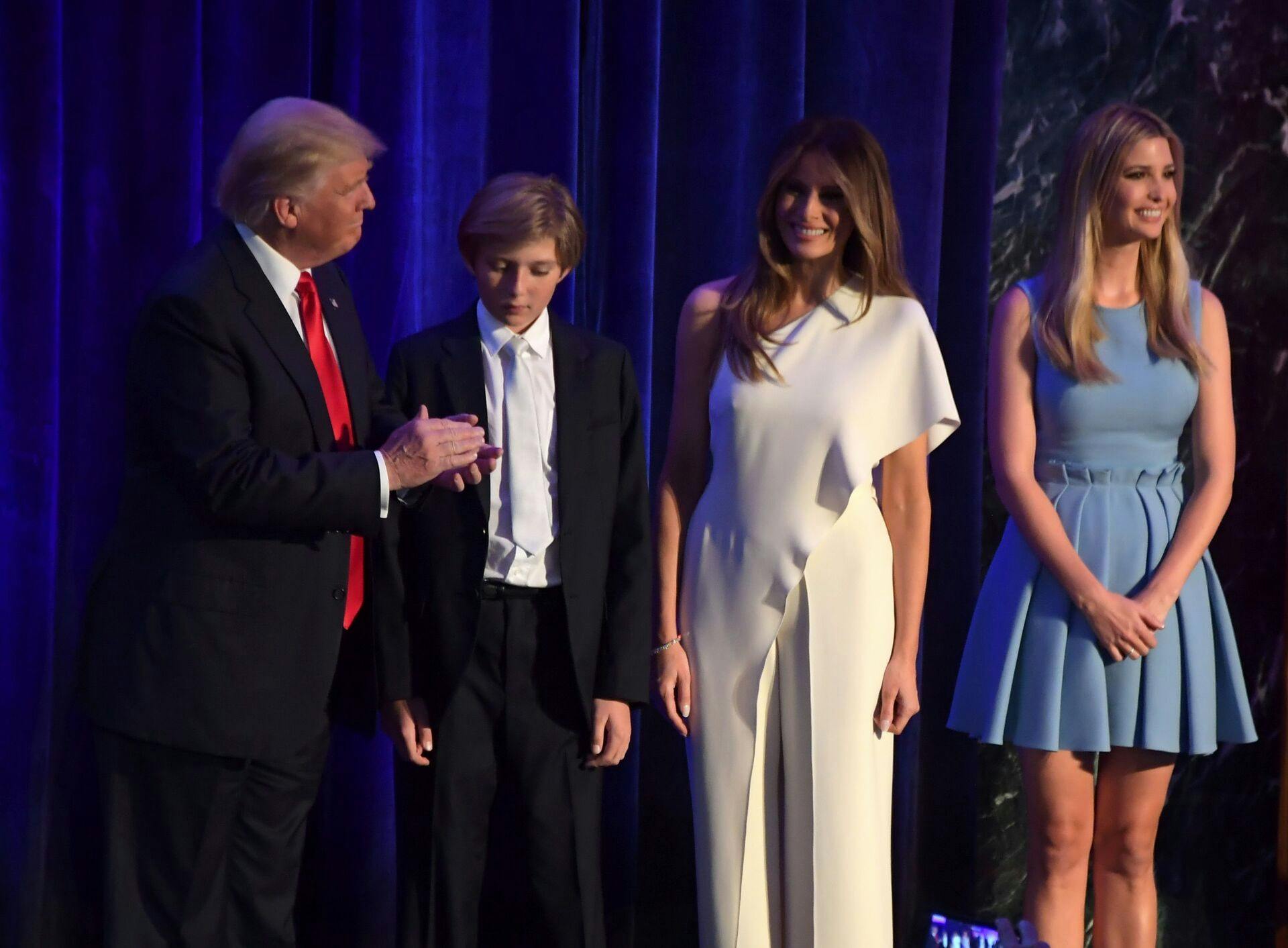 Republican presidential elect Donald Trump (L) gestures next Barron Trump (2L), his wife Melania Trump, and his daughter Ivanka Trump as he arrives to speak during election night at the New York Hilton Midtown in New York on November 9, 2016. / AFP PHOTO / JIM WATSON