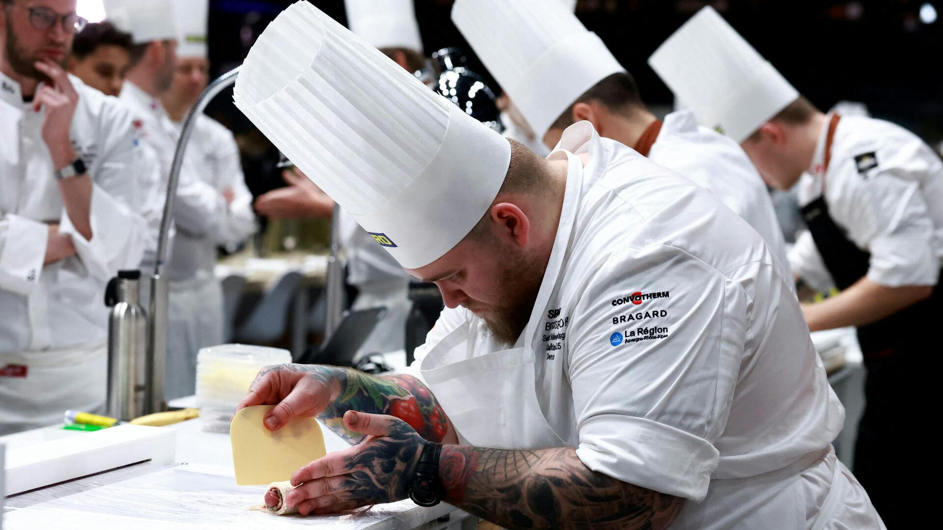 Chef Sebastian Holberg Svendsgaard of Denmark prepares a dish as he competes during the Grand Final of the Bocuse d'Or gastronomic competition in Chassieu near Lyon, France, January 27, 2025. REUTERS/Manon Cruz