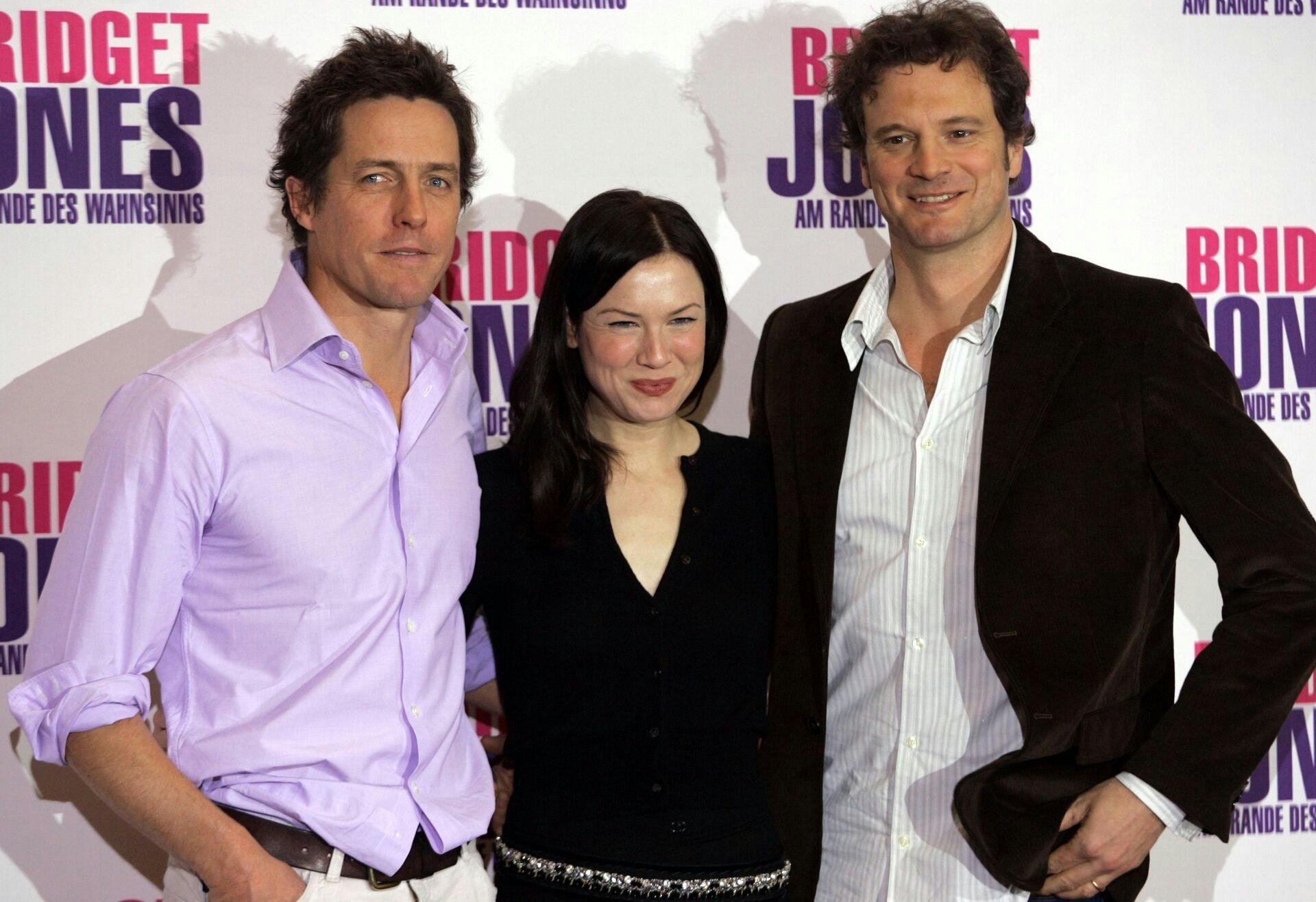 U.S. actress Renee Zellweger (C) and British actor Hugh Grant and Colin Firth (R) pose for the media to promote the movie'Bridget Jones Beyond the Edge of Reason' in Berlin November 12, 2004. REUTERS/Michael Dalder