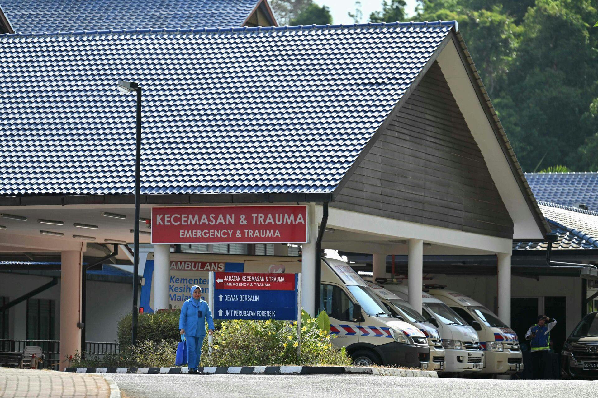 A nurse walks in front of Sultanah Maliha Hospital, where Norway's King Harald has been admitted with an infection, on the Malaysian resort island of Langkawi on February 28, 2024. Norway's King Harald, aged 87 and in poor health, was hospitalised with an infection while on holiday in Malaysia, the Royal House of Norway said on February 27. (Photo by Mohd RASFAN / AFP)