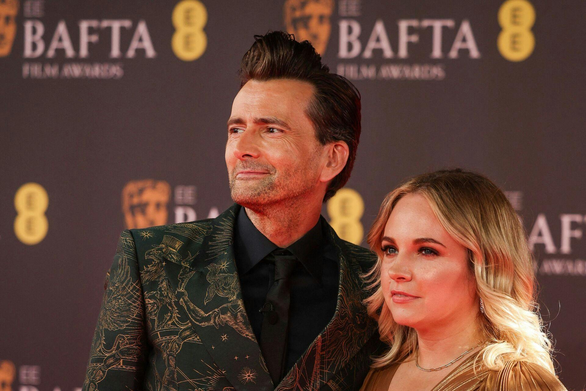 British actor David Tennant and Georgia Tennant pose on the red carpet upon arrival at the BAFTA British Academy Film Awards at the Royal Festival Hall, Southbank Centre, in London, on February 18, 2024. (Photo by Adrian DENNIS / AFP)