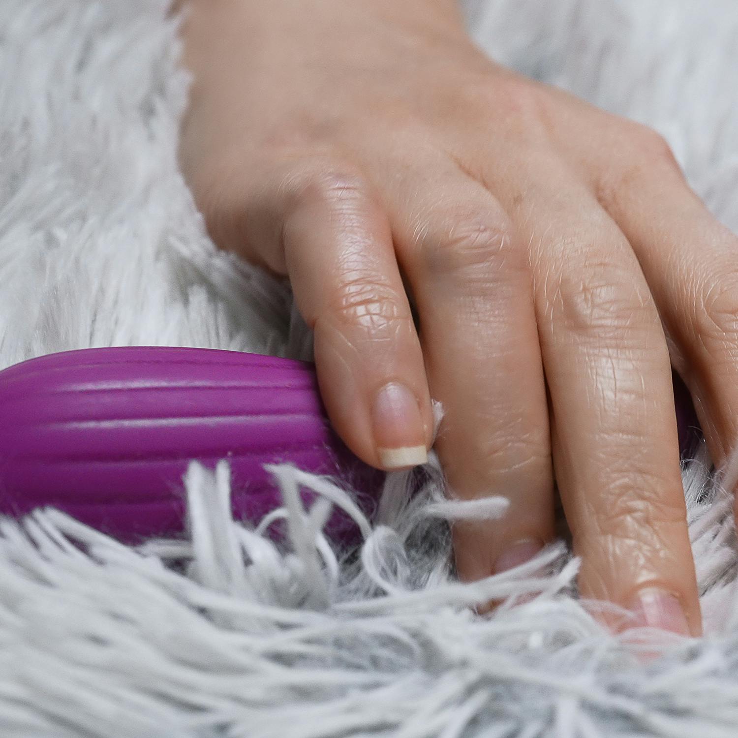 Woman taking pulse vibrating g-spot stimulator.