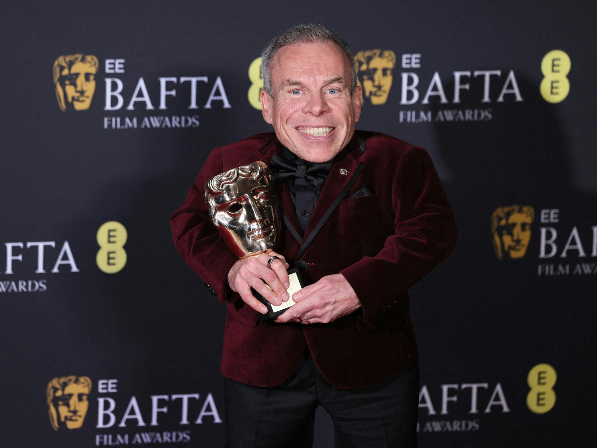 Warwick Davis poses in the winners' room with the Fellowship award during the 2025 British Academy of Film and Television Awards (BAFTA) at the Royal Festival Hall in the Southbank Centre, London, Britain, February 16, 2025. REUTERS/Isabel Infantes